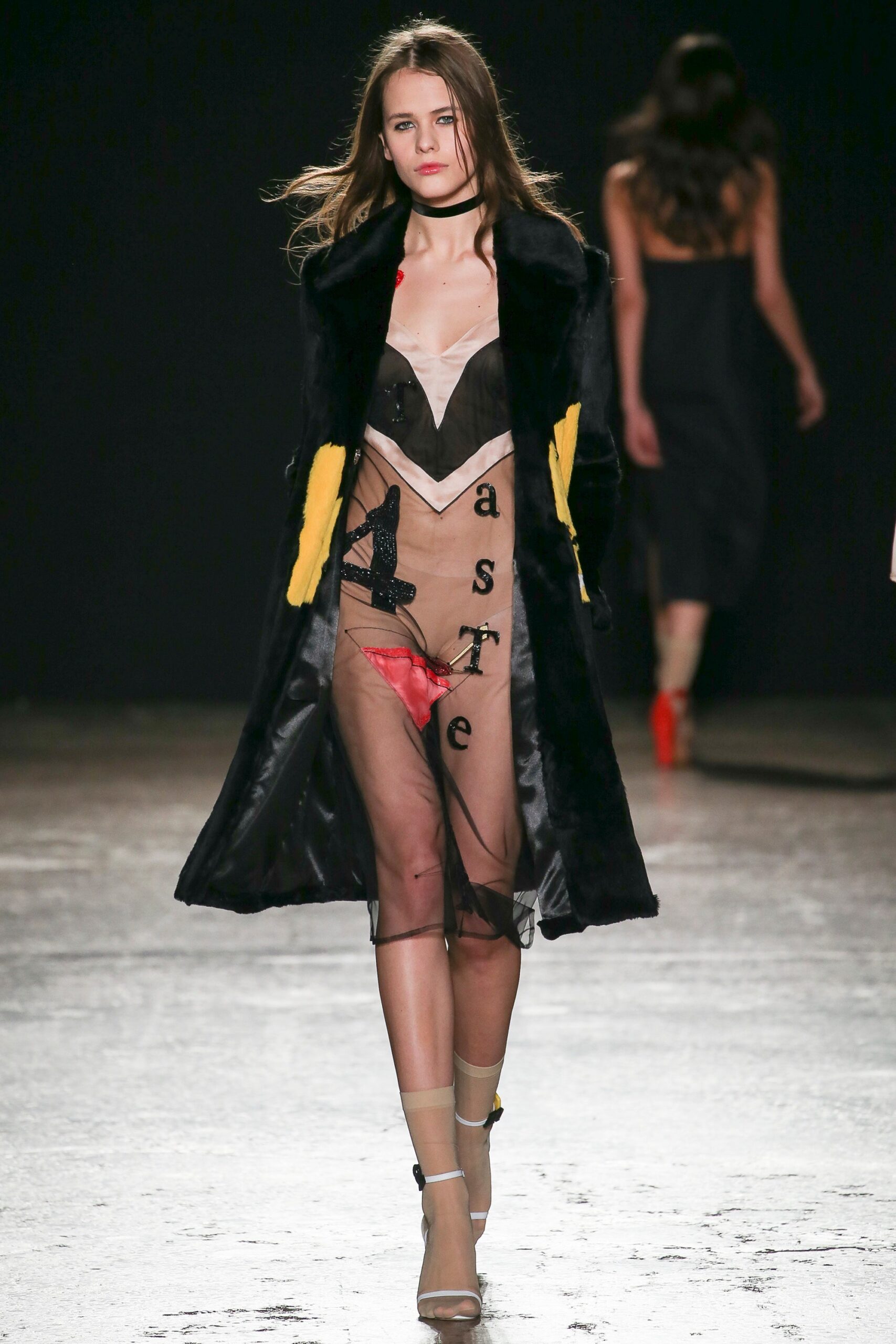black faux-fur coat and mesh dress
