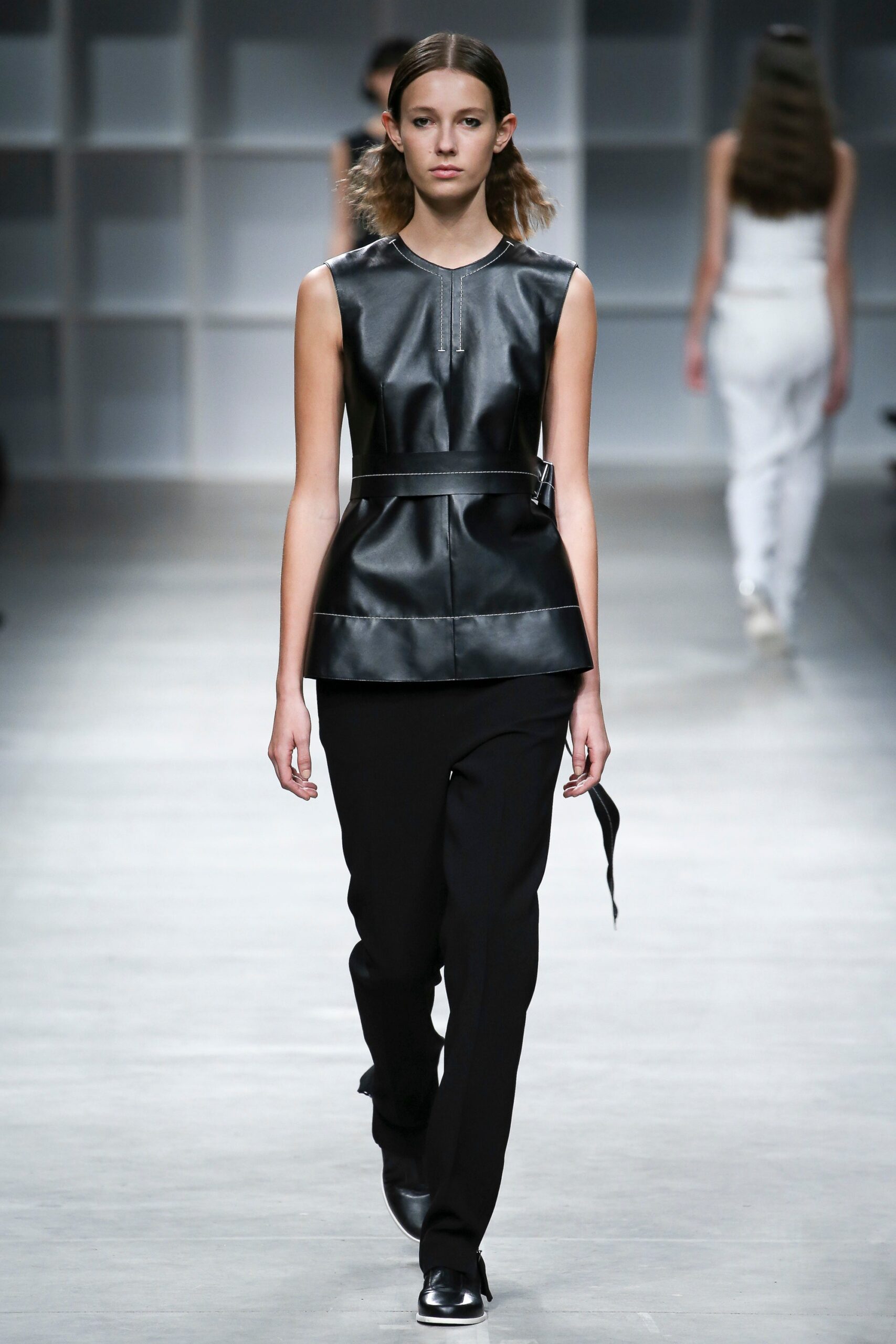 black leather sleeveless top and slim pants