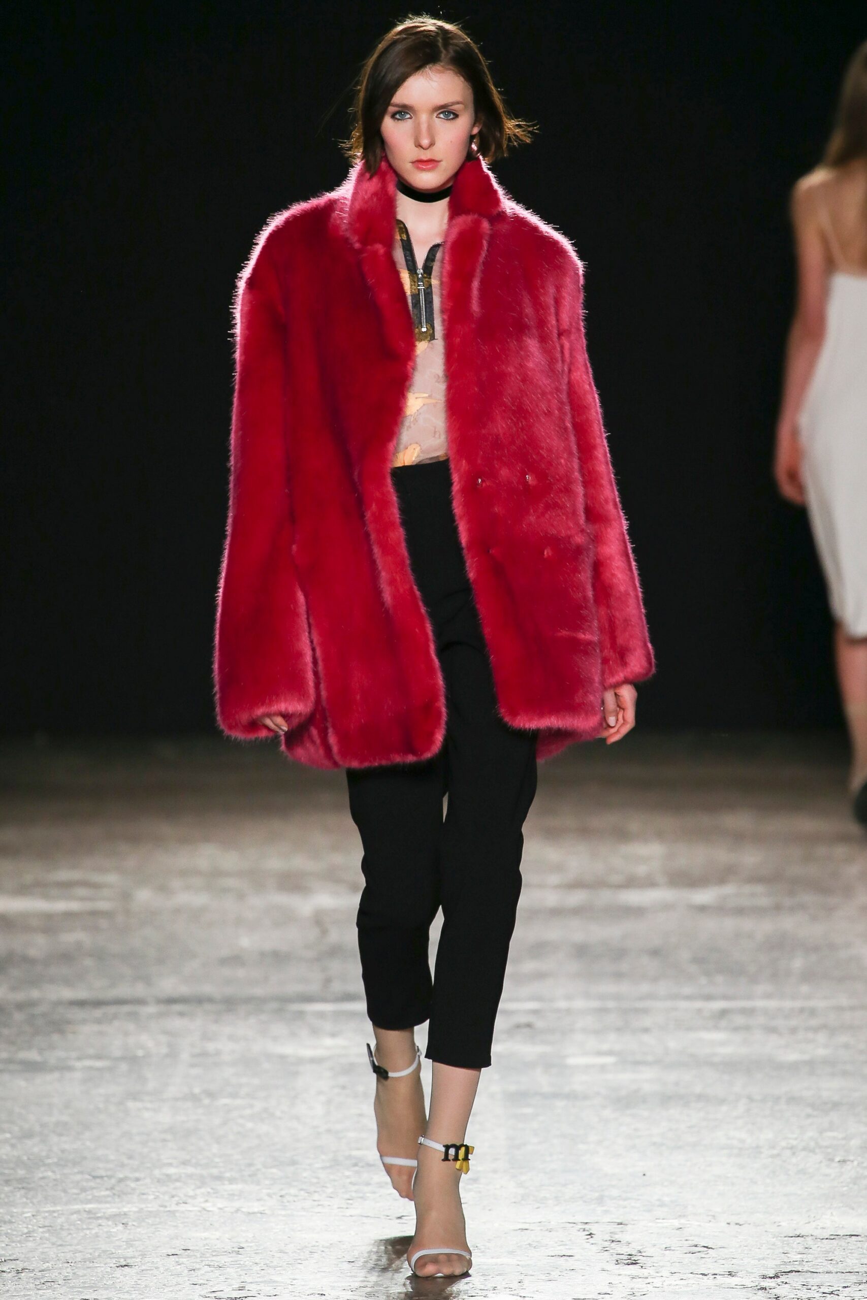 red faux-fur coat with black pants