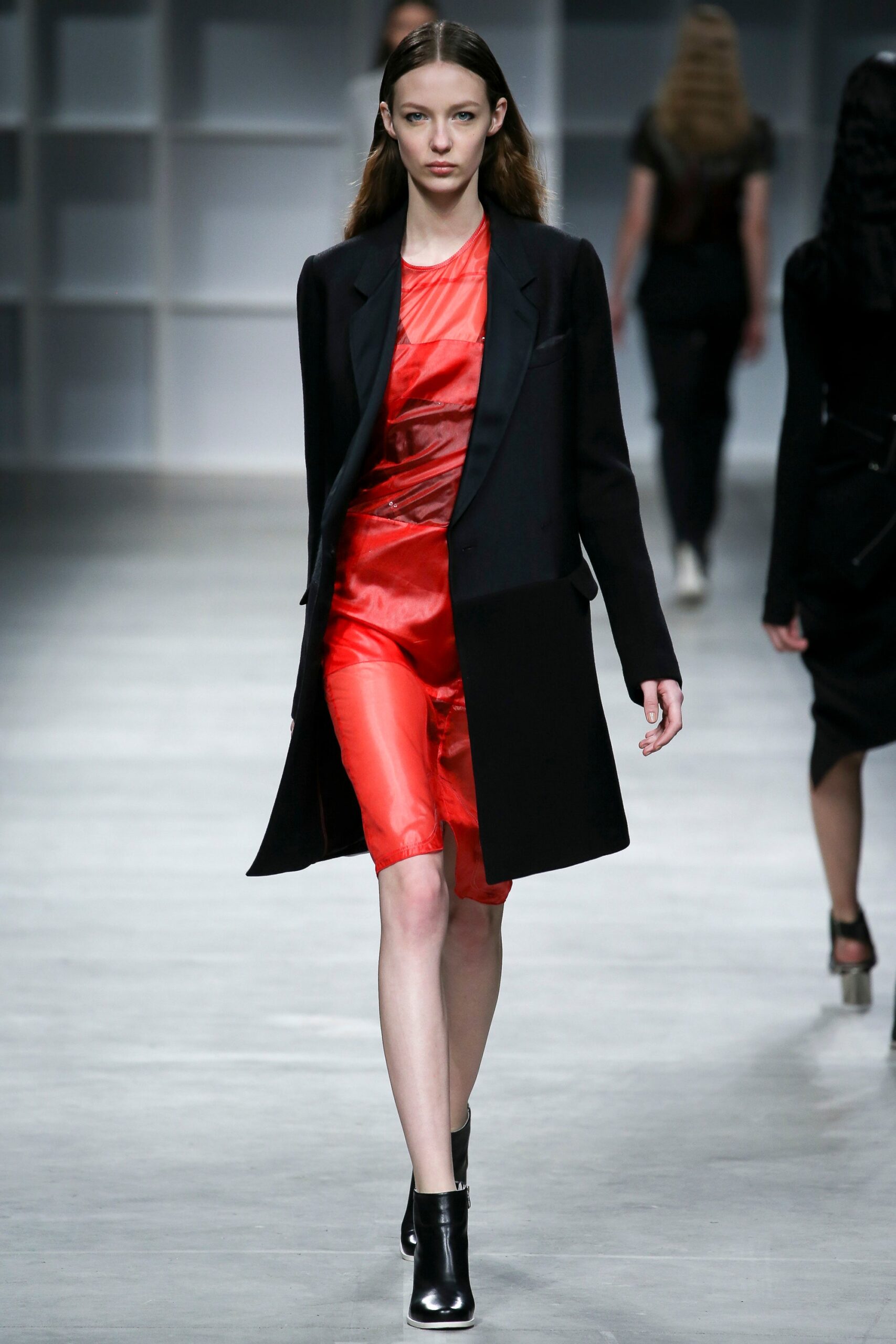 red silk sleeveless dress with black coat