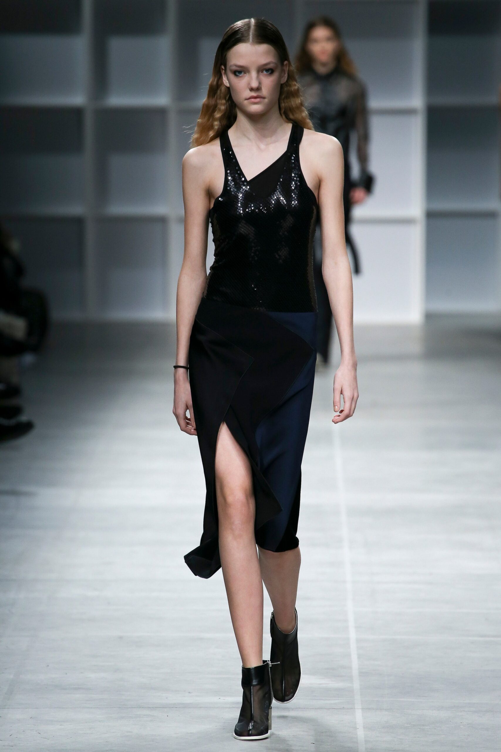 black sequined sleeveless top and asymmetric skirt
