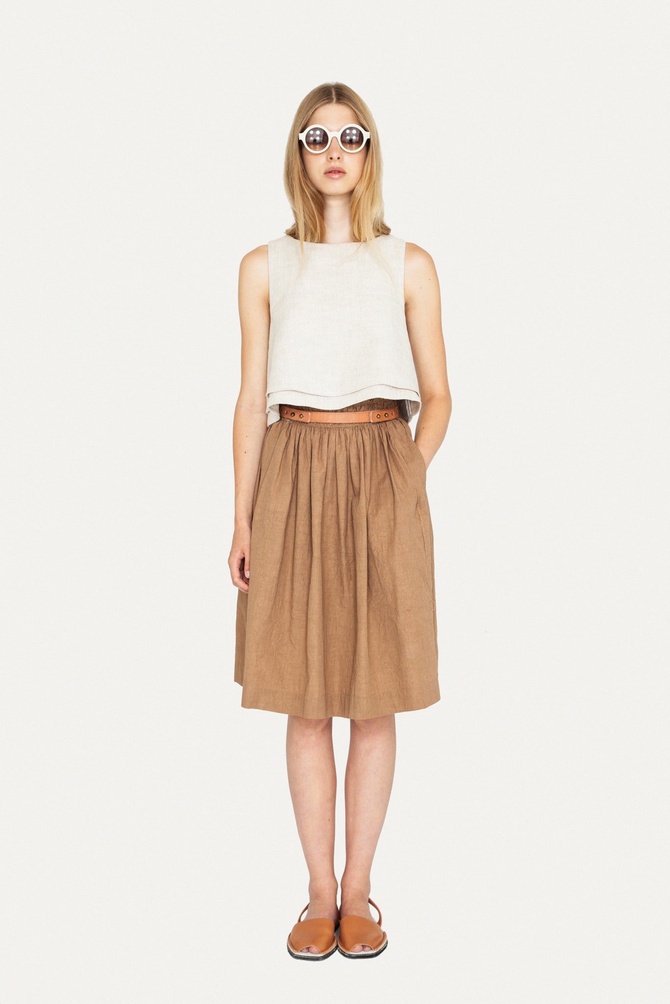 white linen cropped top and brown pleated skirt