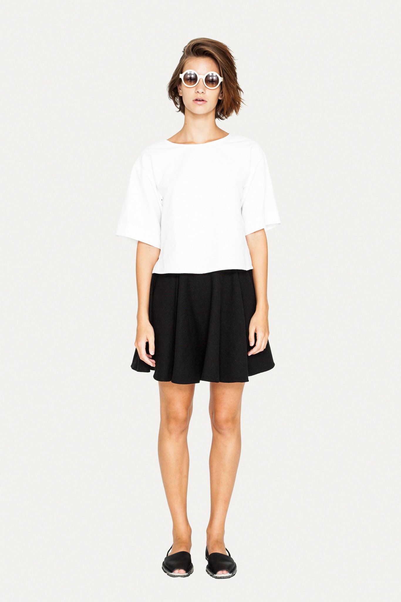 white cropped top black mini skirt