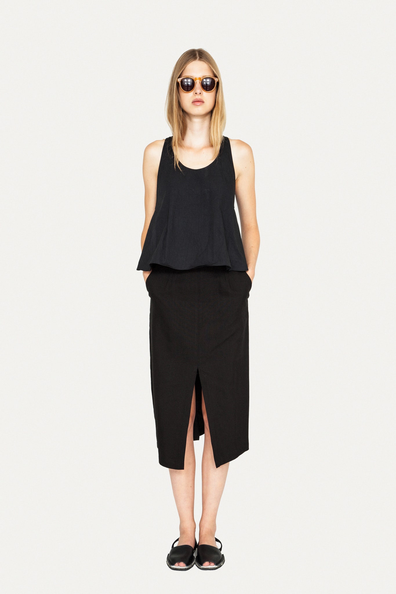 black relaxed top and fitted midi skirt
