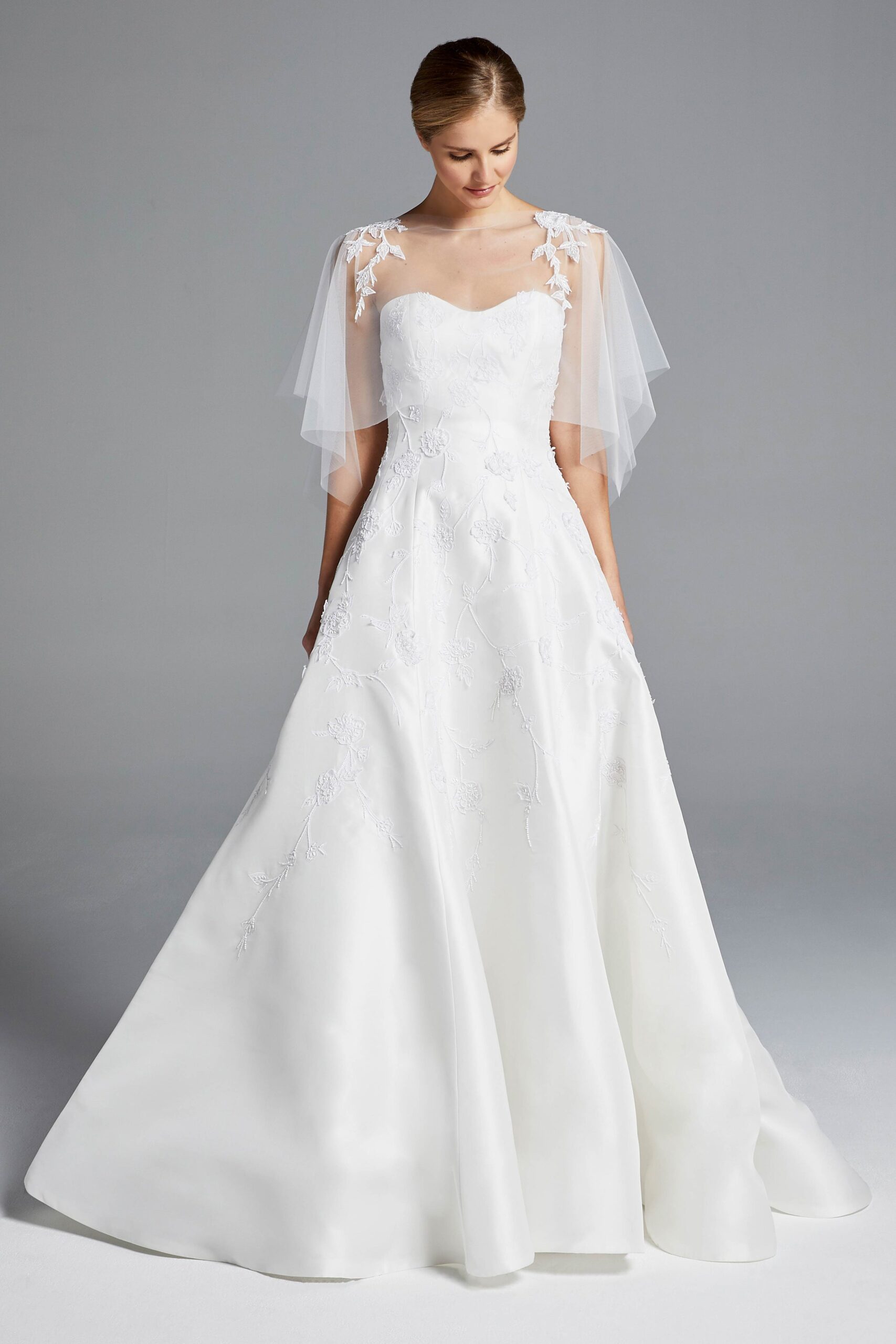 white embroidered gown with cape