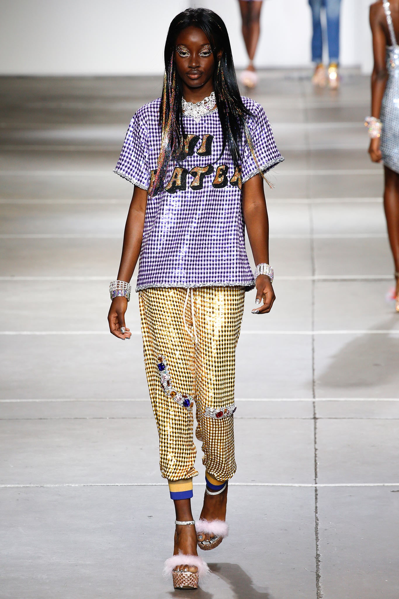 purple printed t-shirt with gold pants