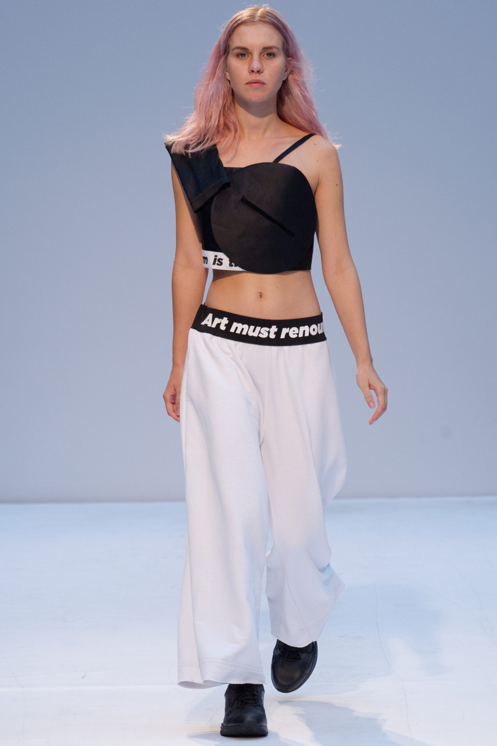 black asymmetric top and white wide-leg pants