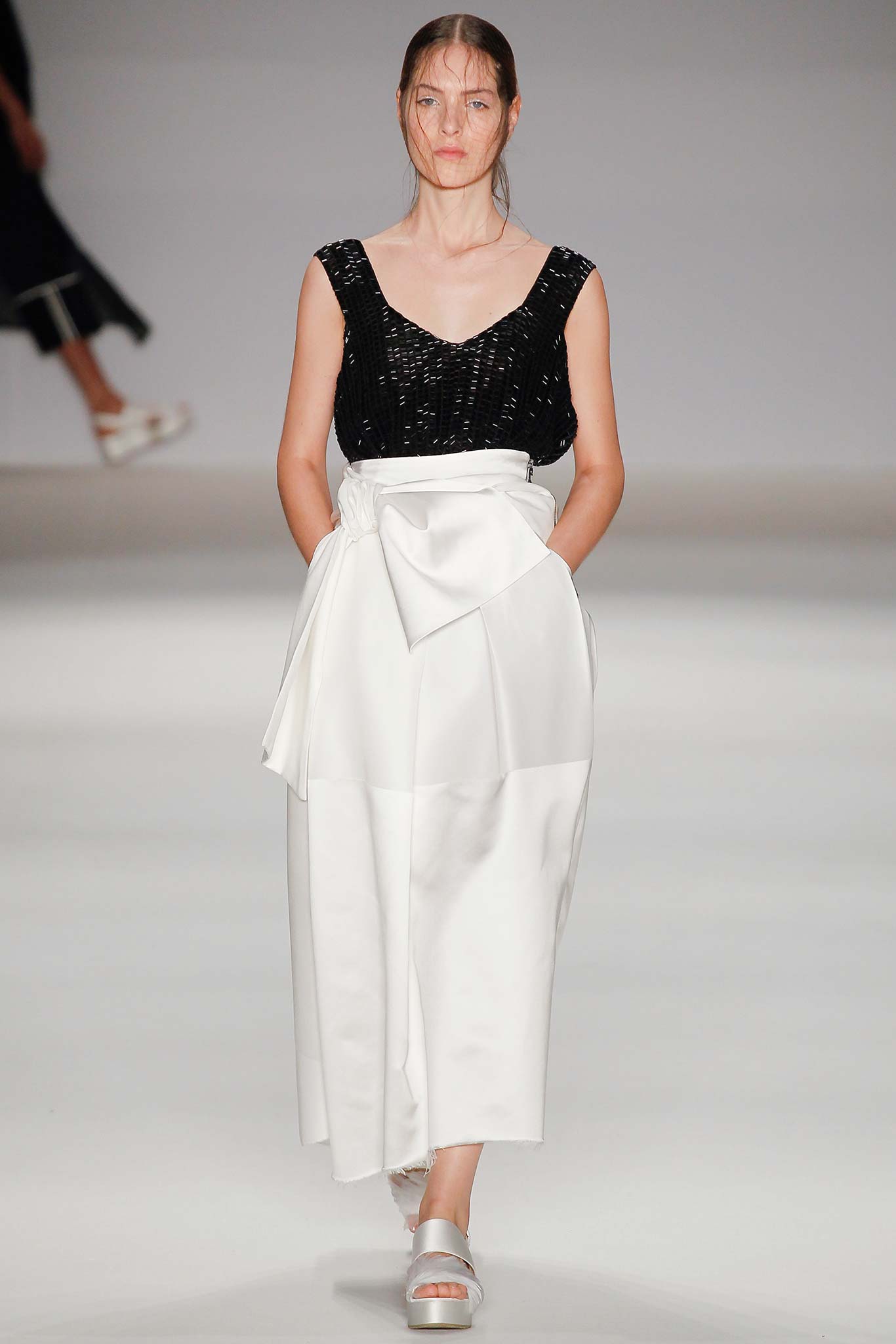 black silk sleeveless top and white skirt