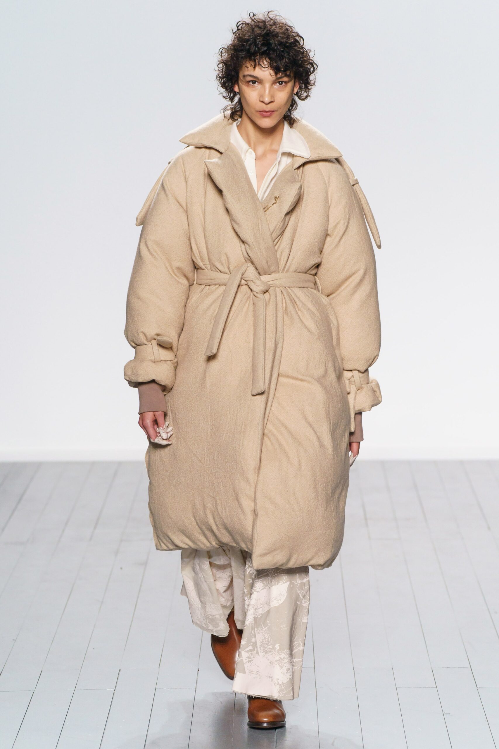 beige wool relaxed coat and white pants