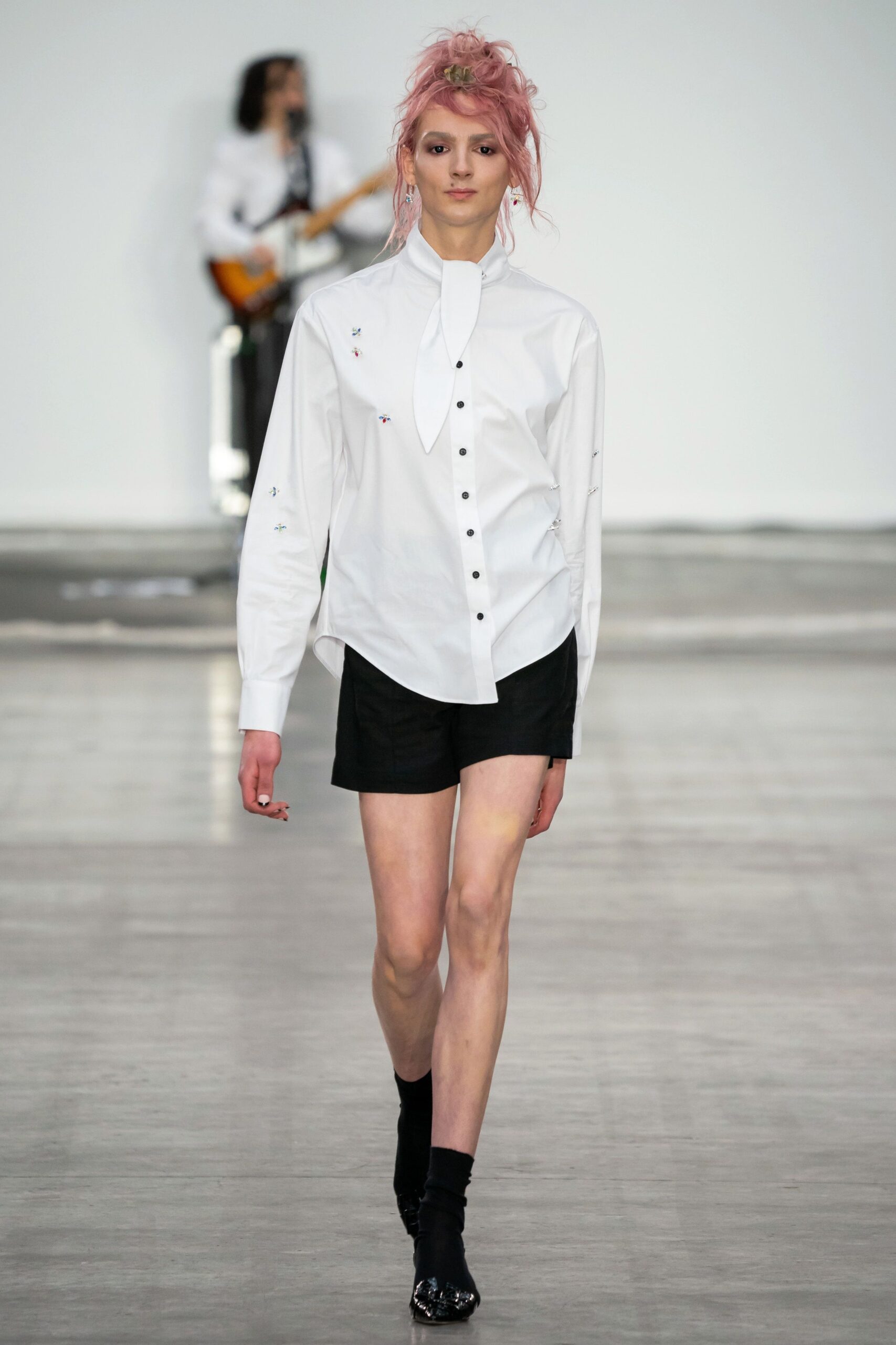 white fitted shirt and black shorts