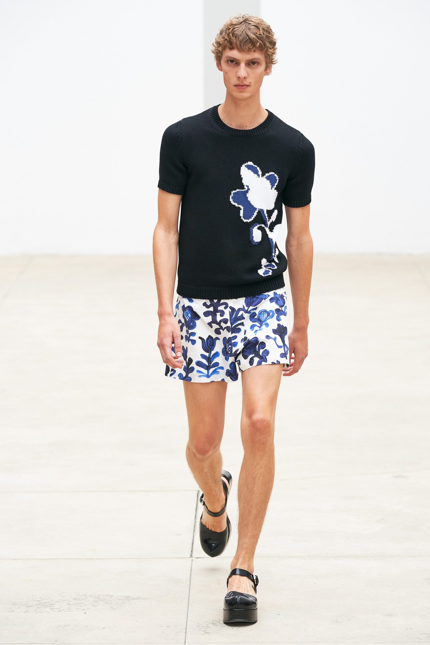 black fitted top with floral shorts