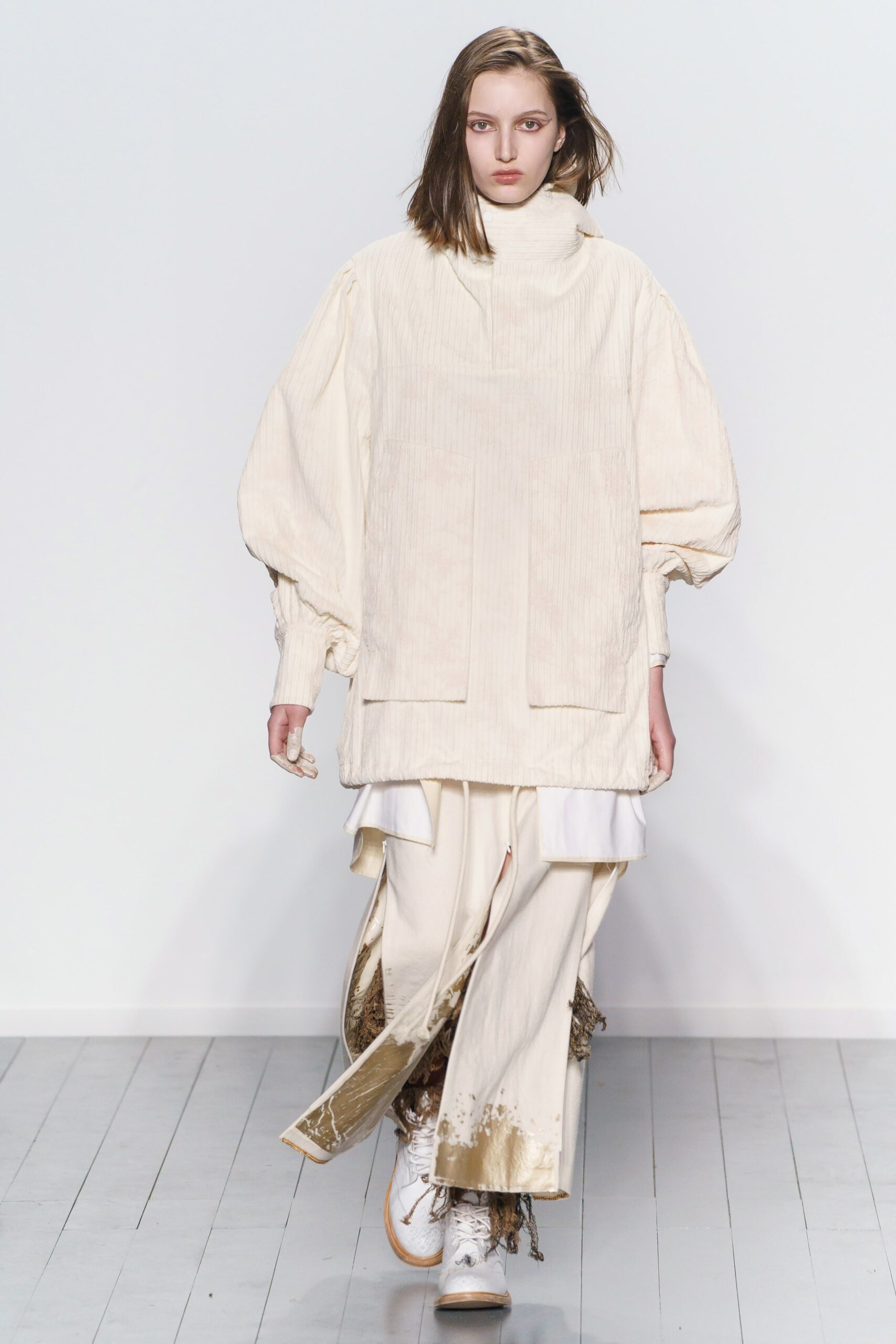 white relaxed top with beige pants