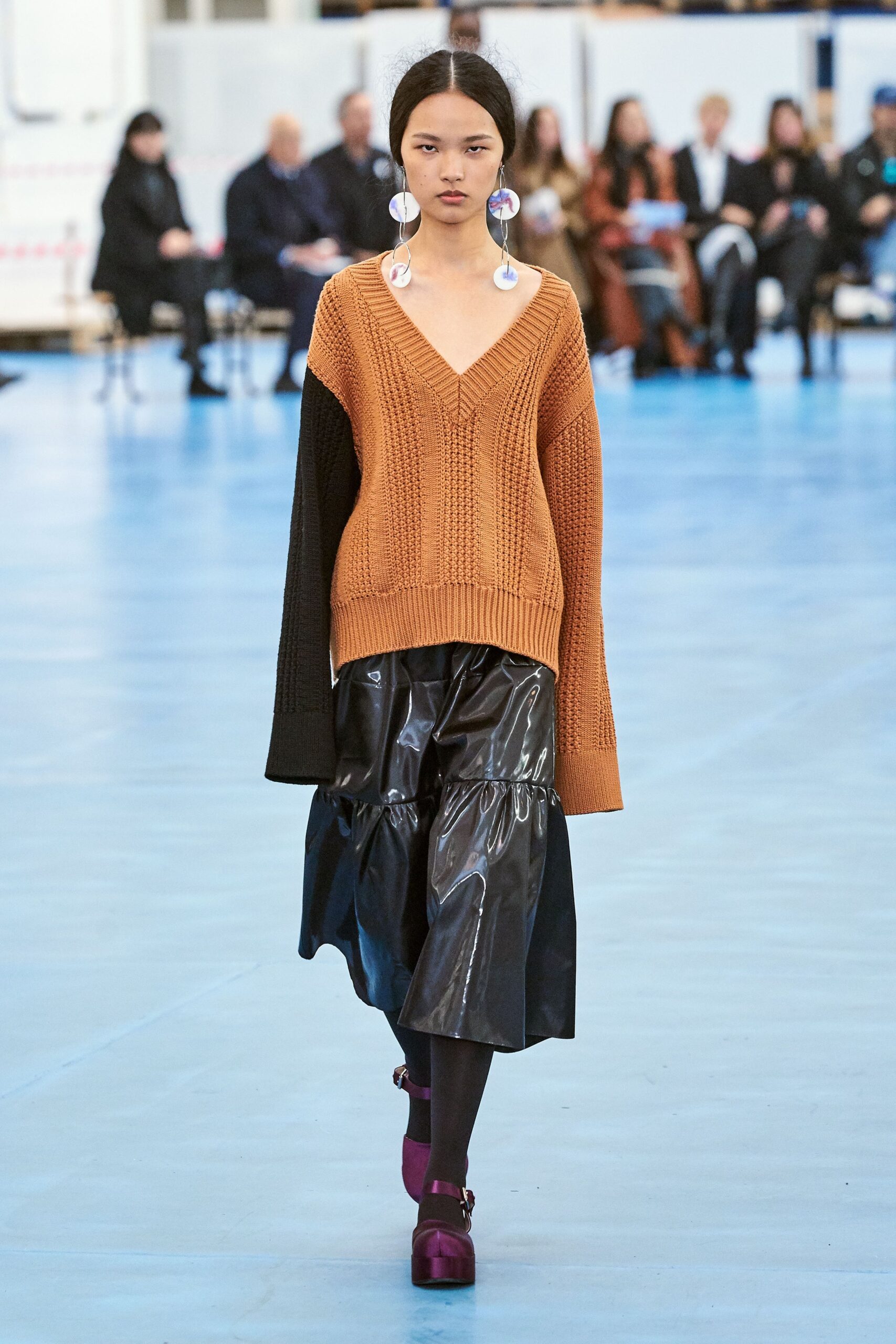 orange and black relaxed sweater with pleated skirt