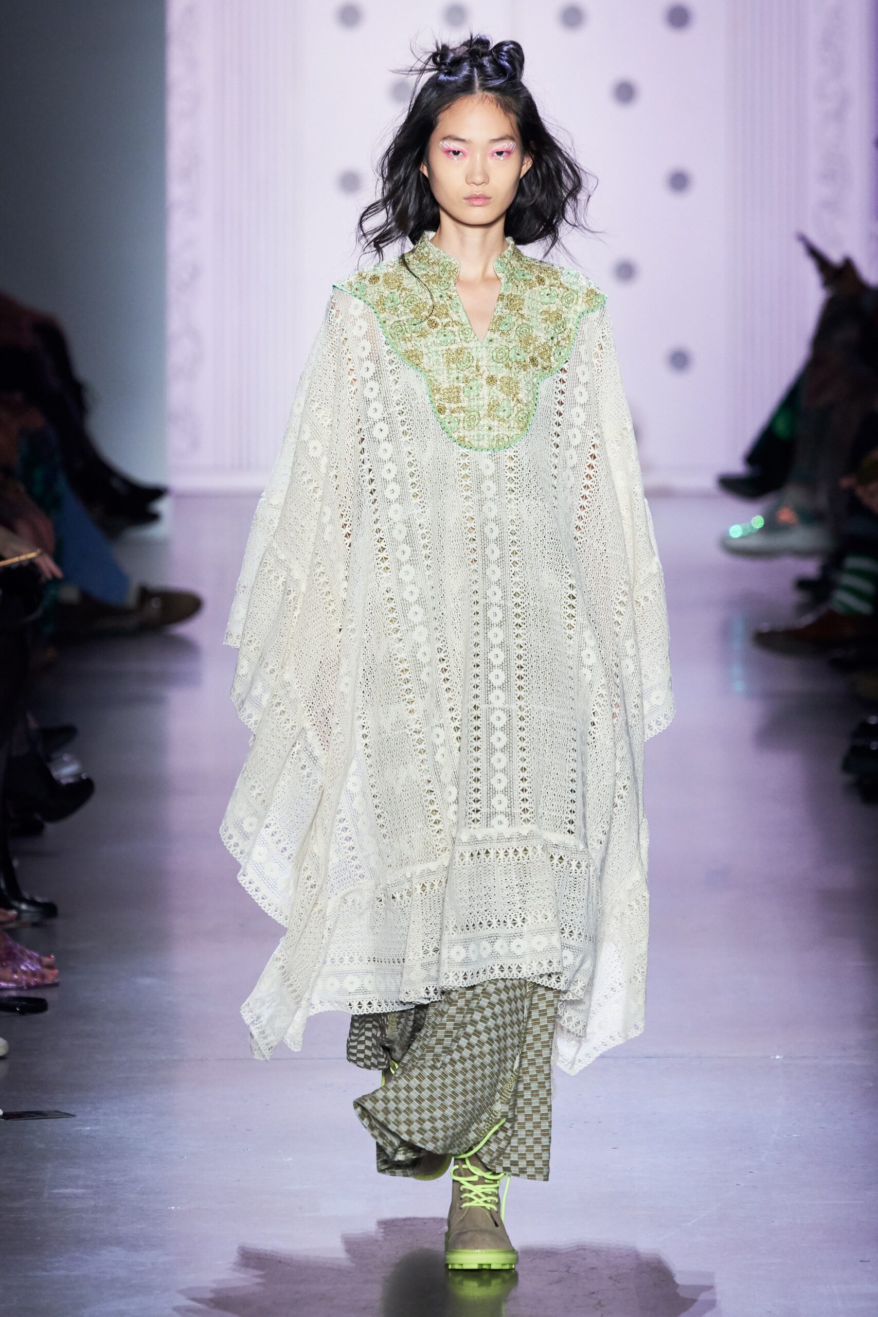 white embroidered poncho with green pants
