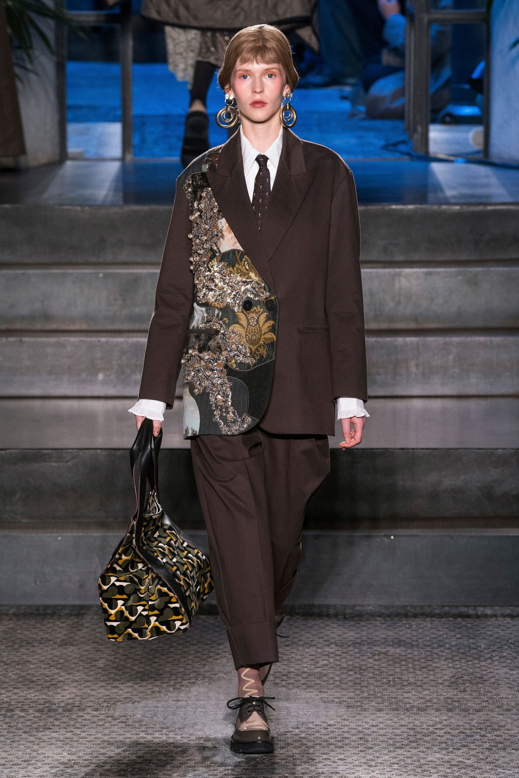 brown tailored suit with printed bag