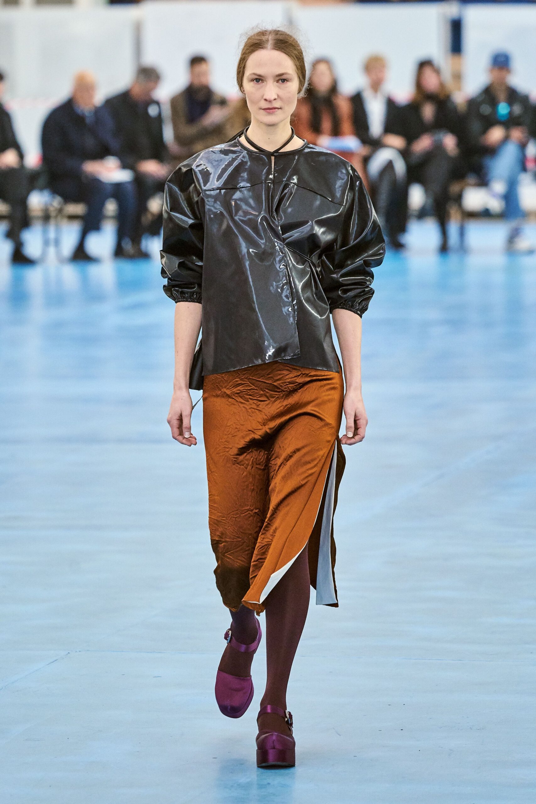 black vinyl relaxed top with orange skirt
