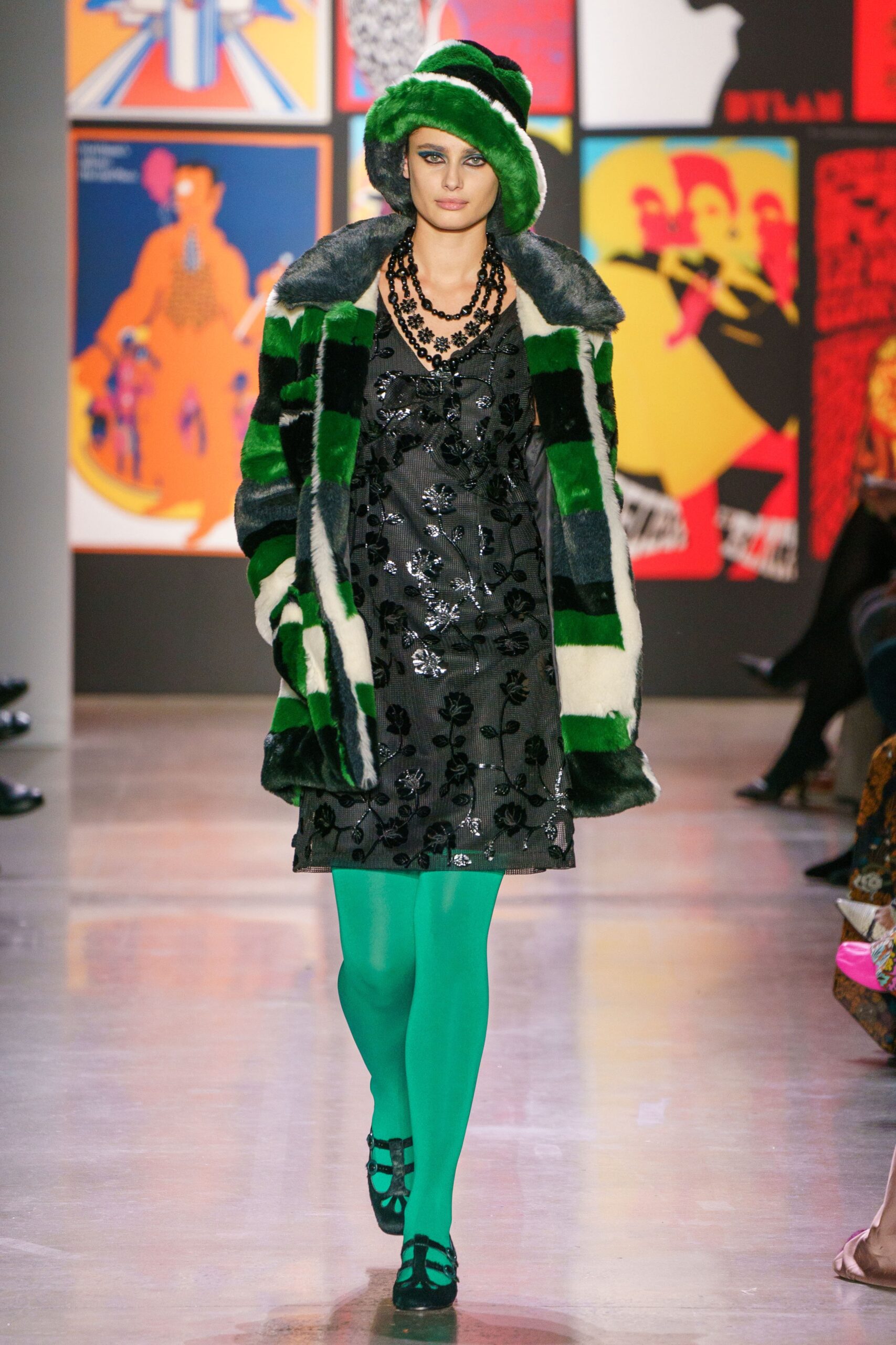 green faux-fur coat with black dress