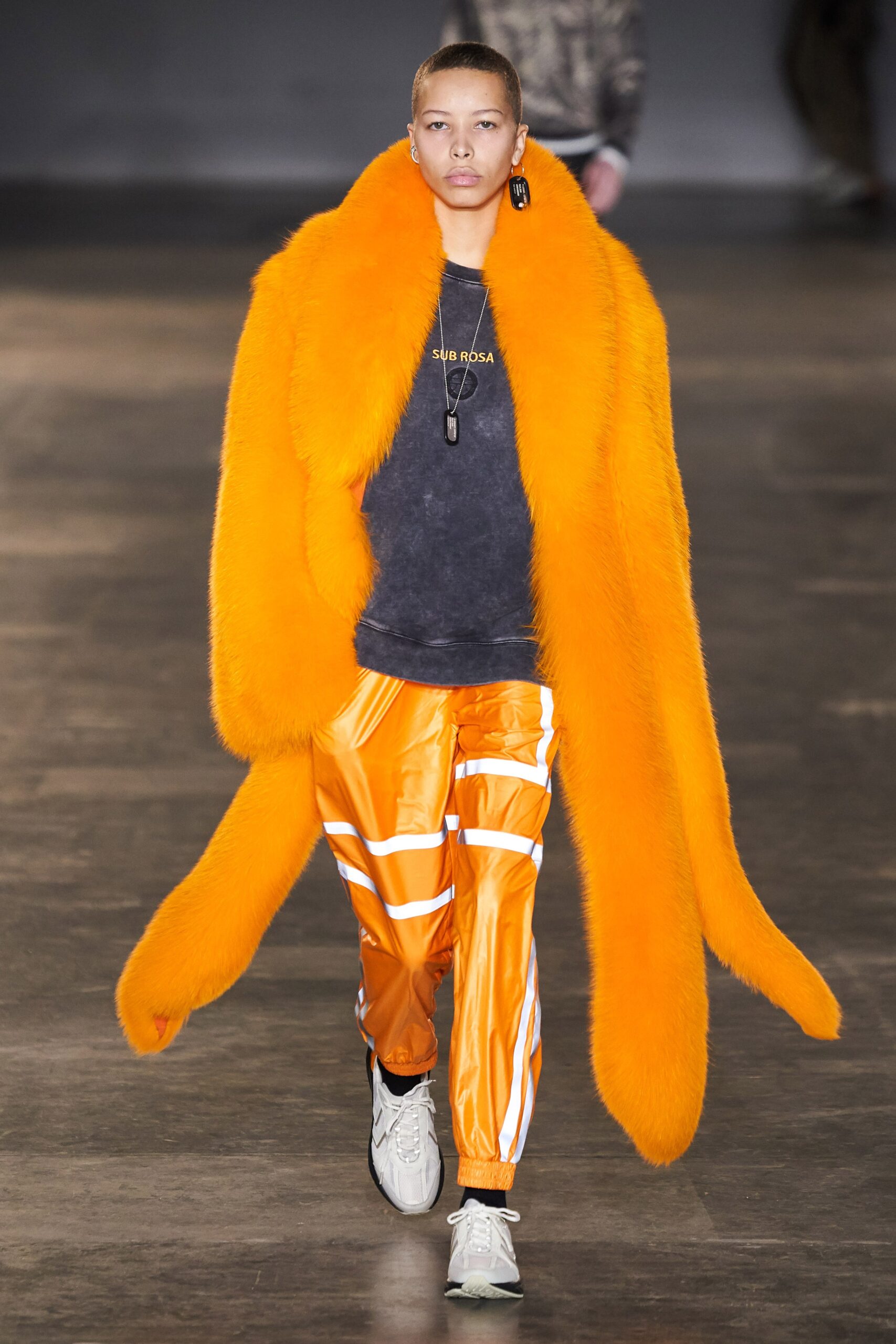 orange faux-fur coat with black top