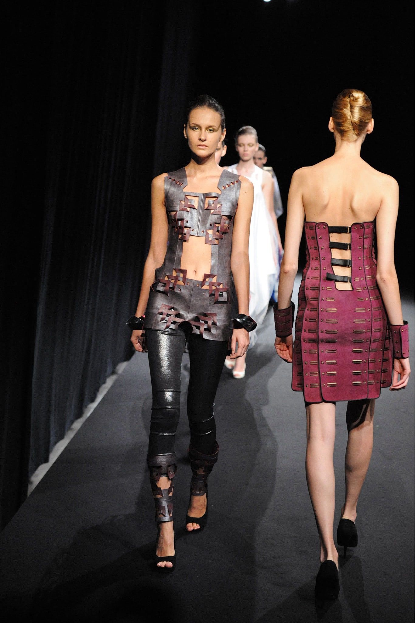 black leather fitted catsuit and purple dress