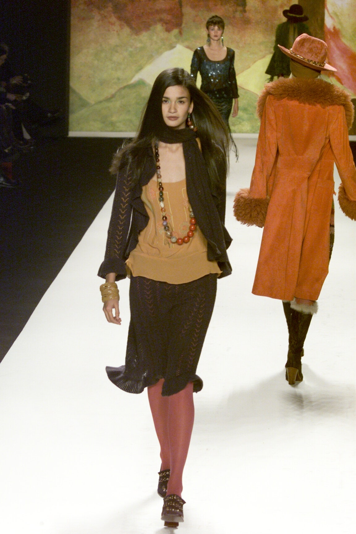 orange sleeveless top with black skirt