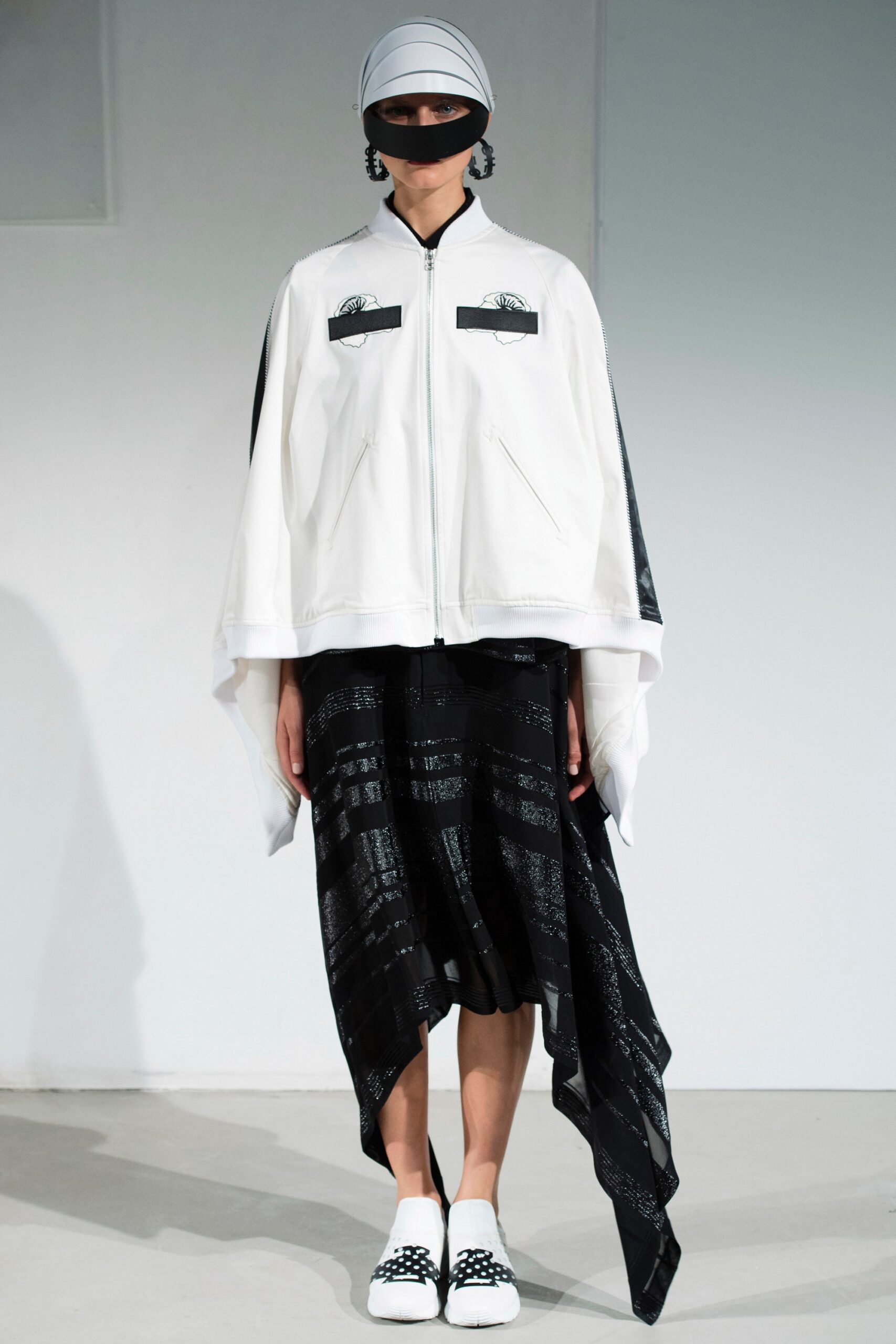 white relaxed jacket and black asymmetric skirt