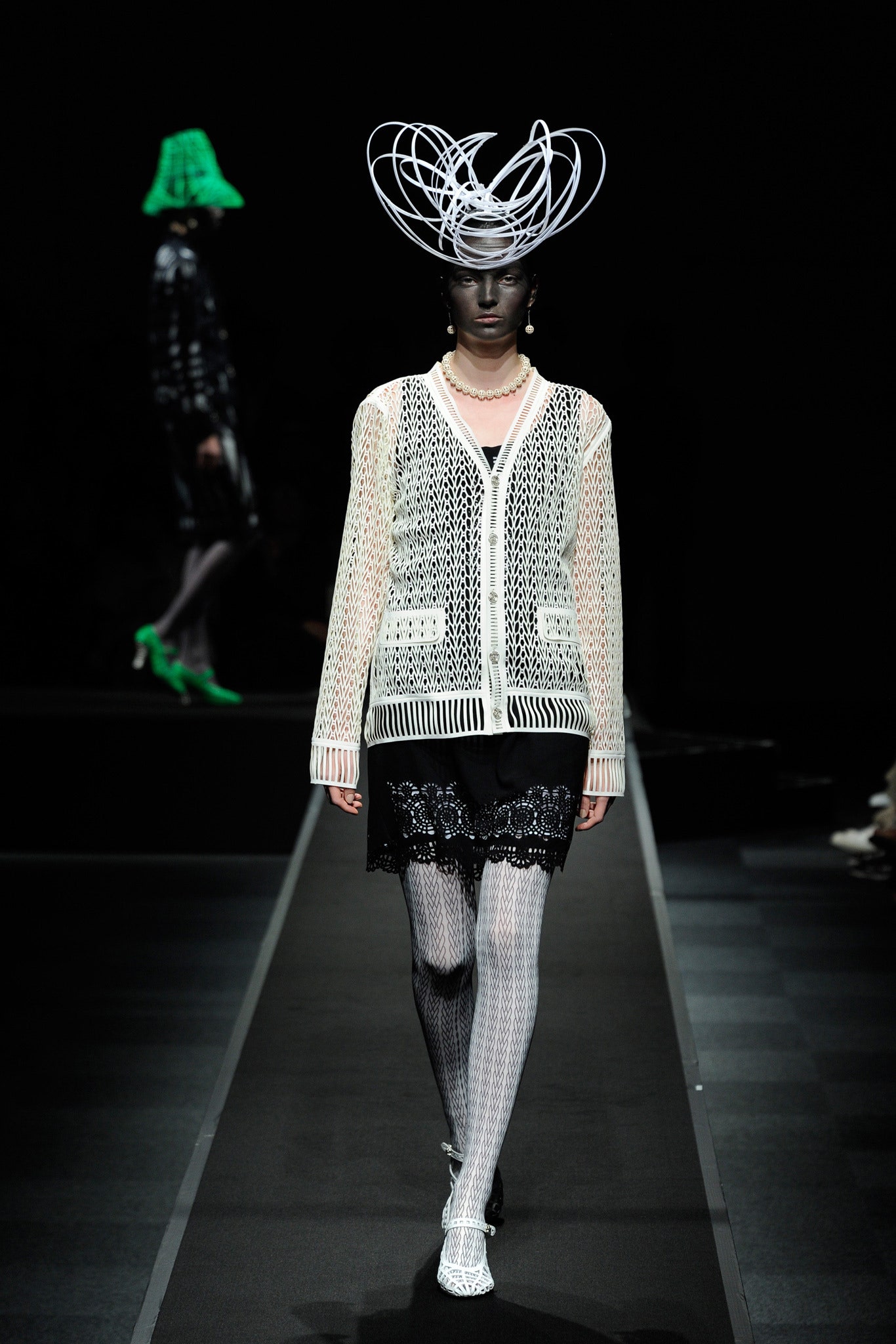 white relaxed cardigan and black lace mini skirt