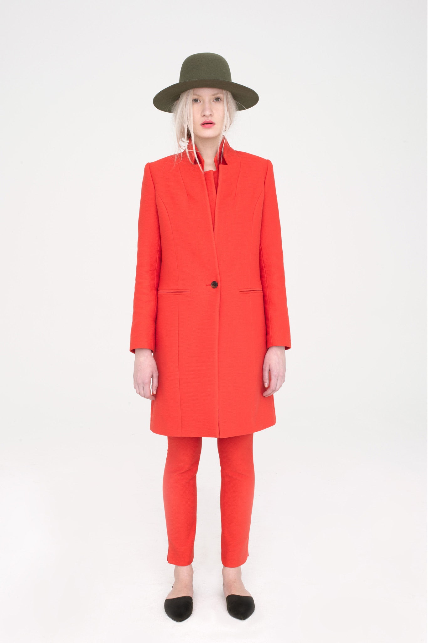red tailored coat with green hat