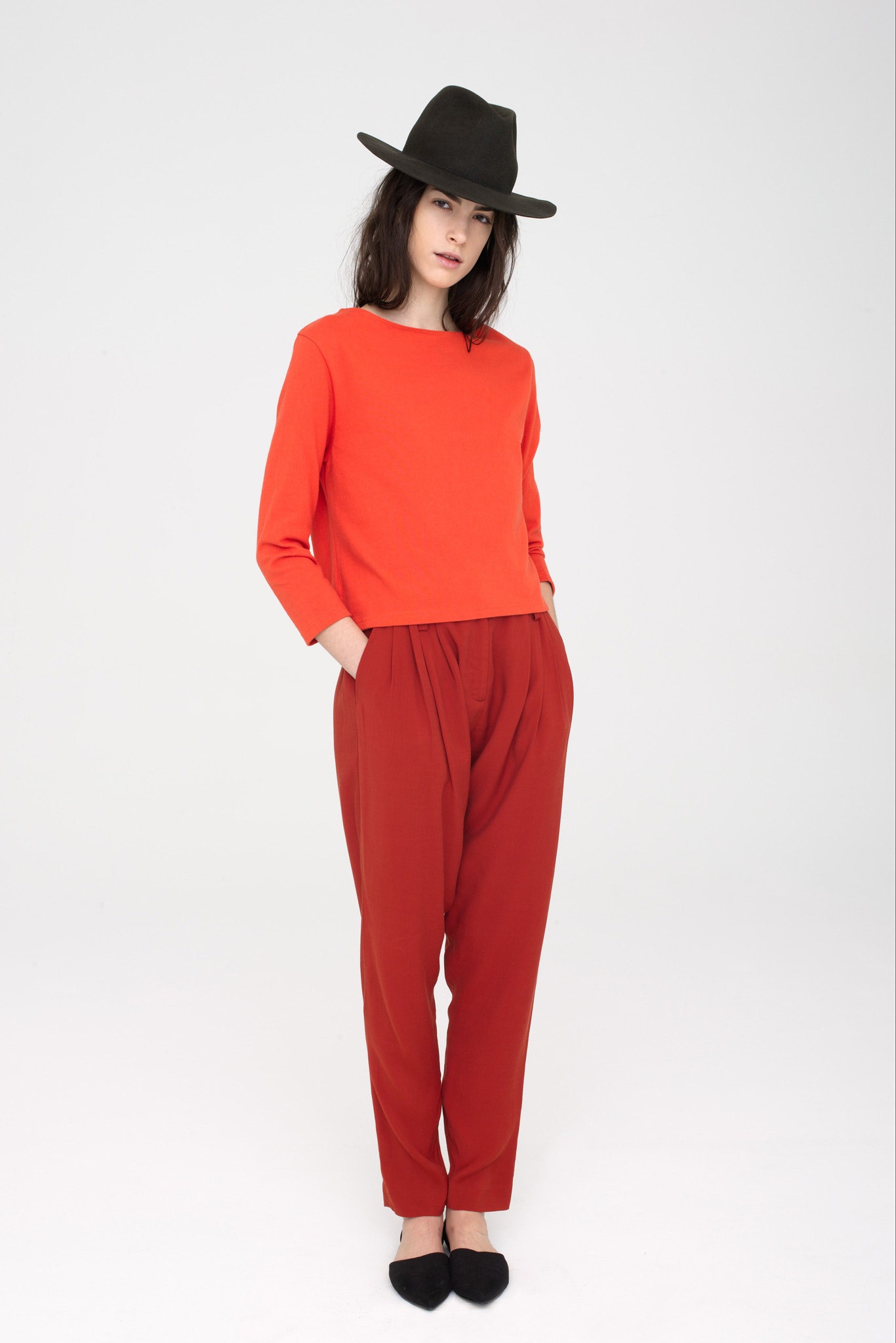 red relaxed top with brown pants