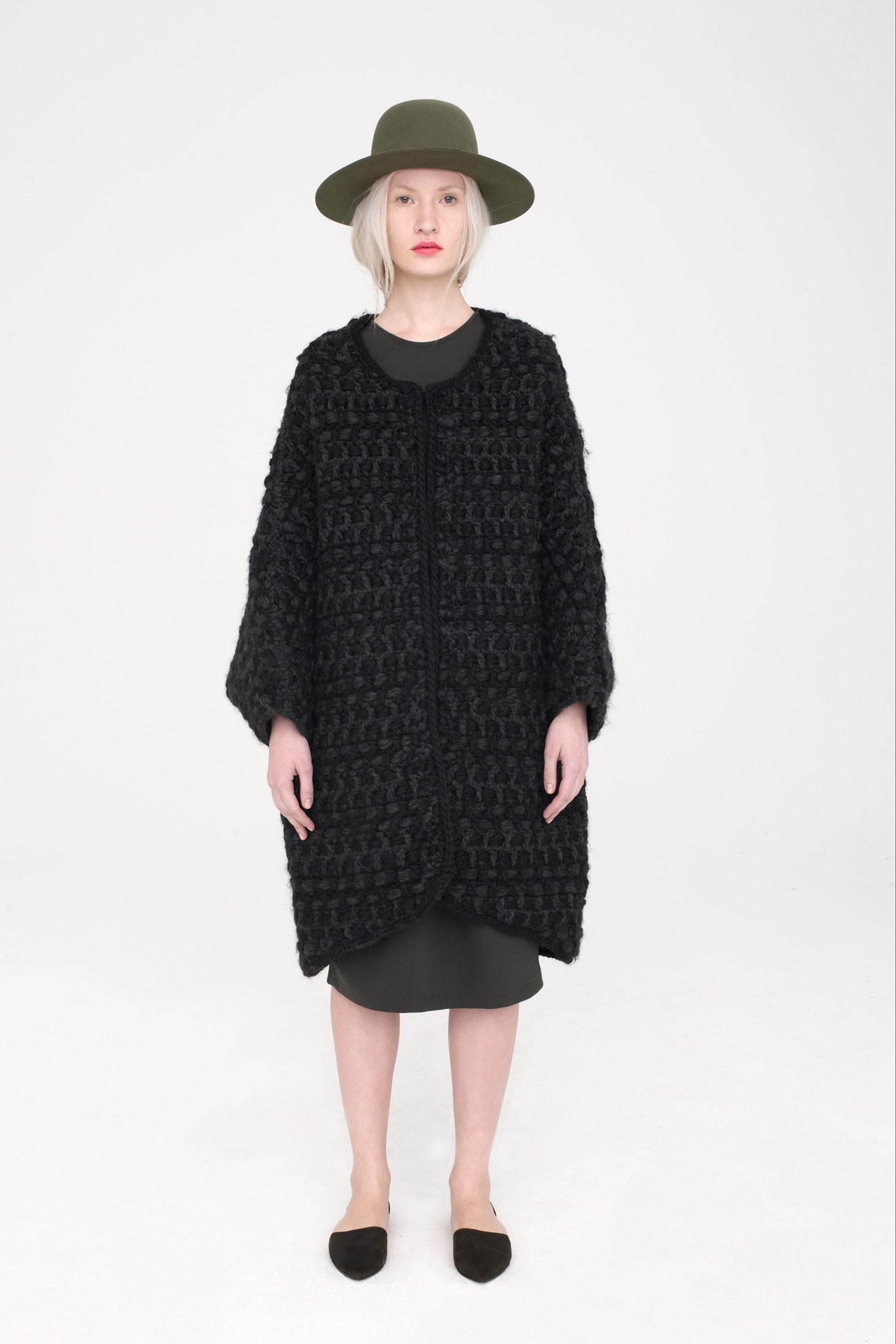 black wool coat with green hat