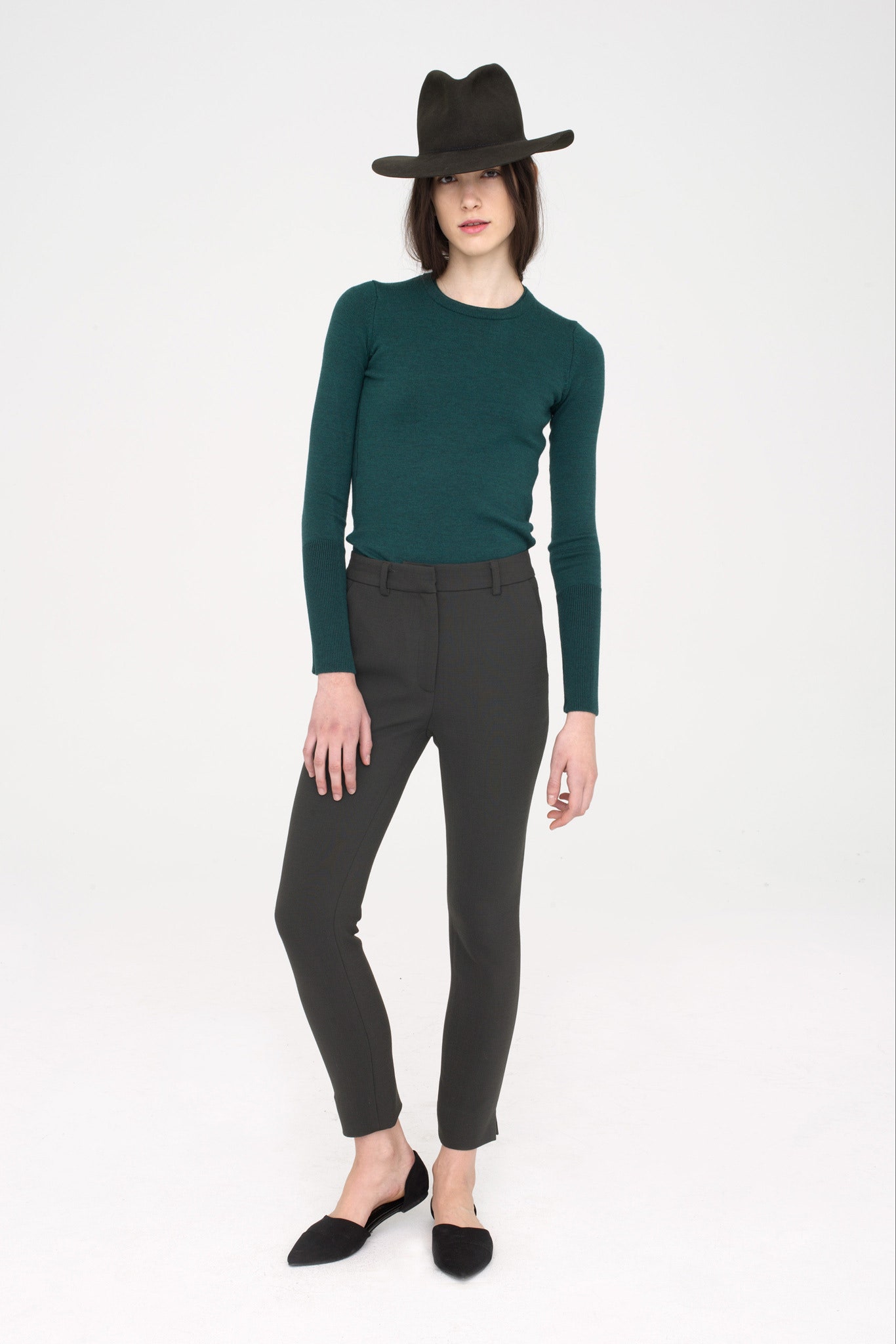 green fitted top with black pants