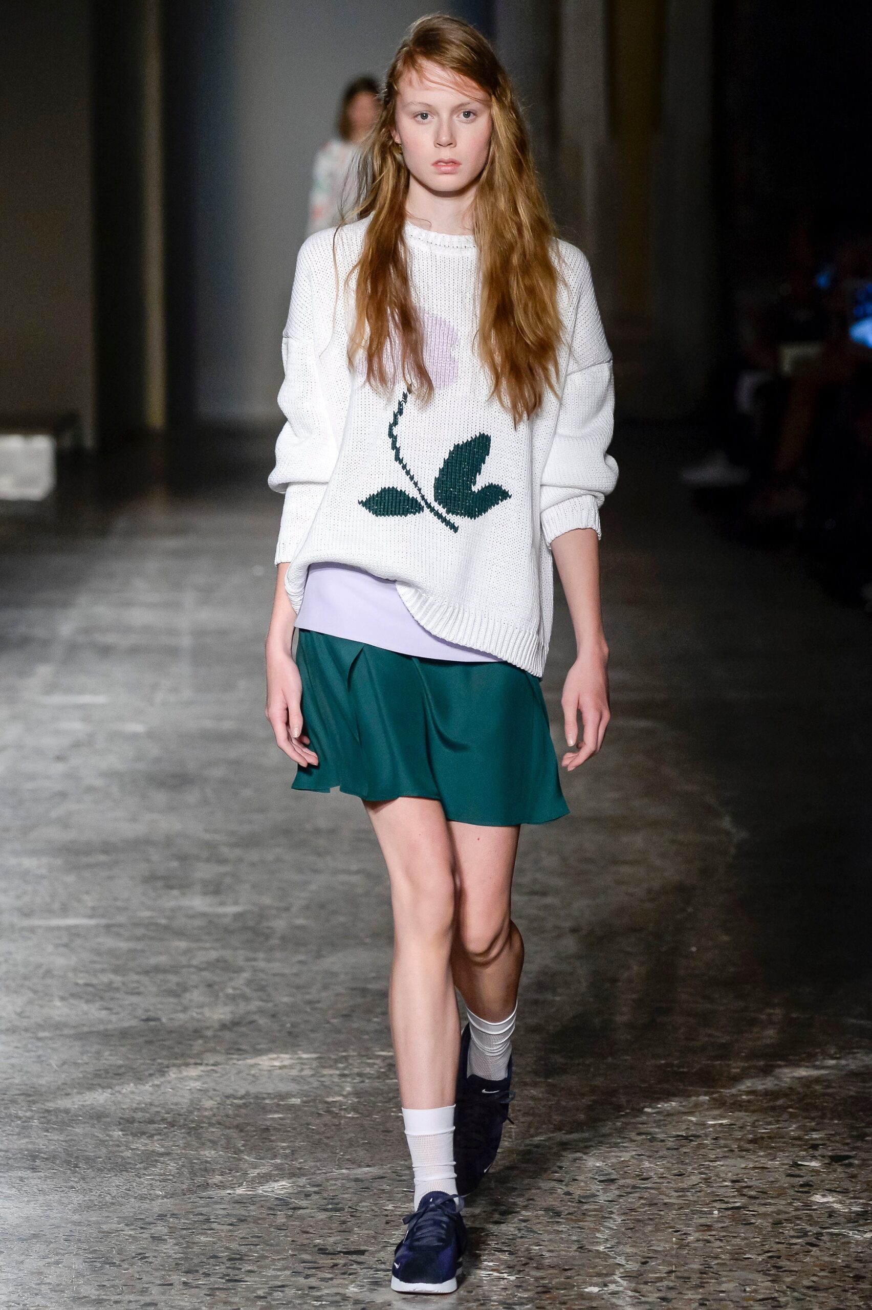 white relaxed sweater with green flared skirt