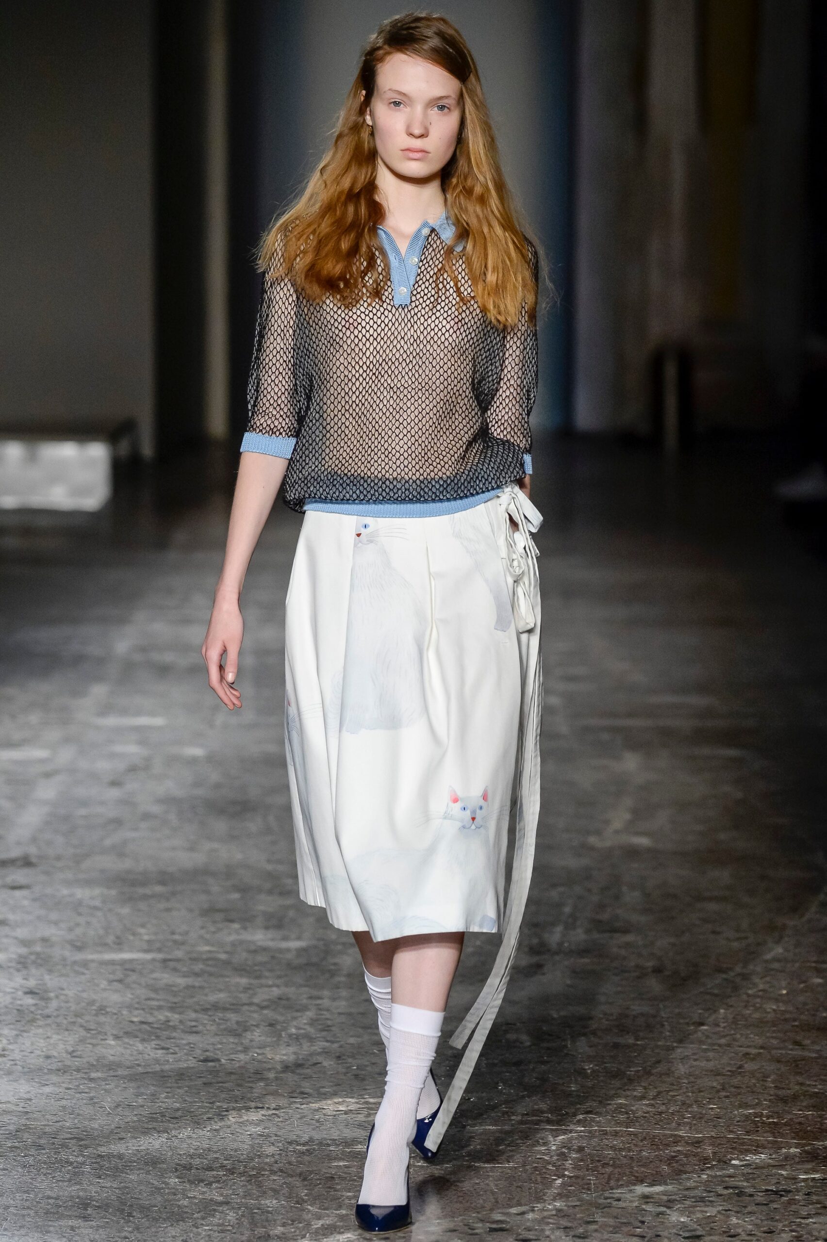 black mesh top and white pleated skirt