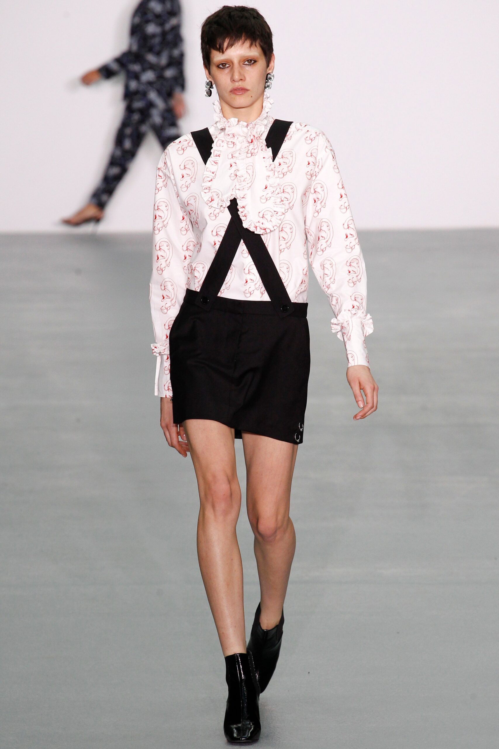 fitted white ruffled shirt with black shorts