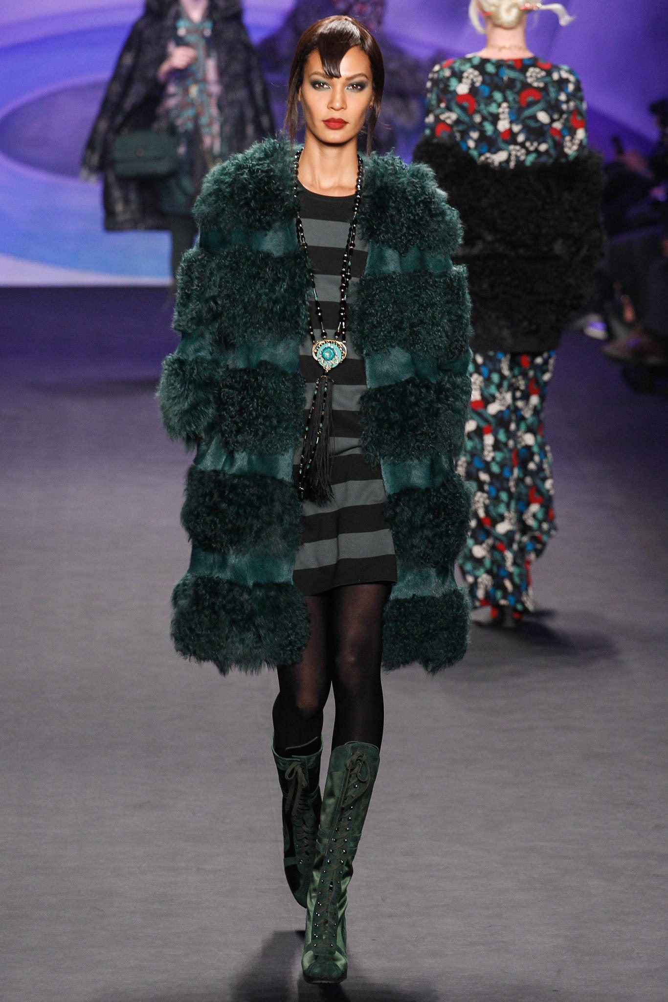 green faux-fur coat with black dress