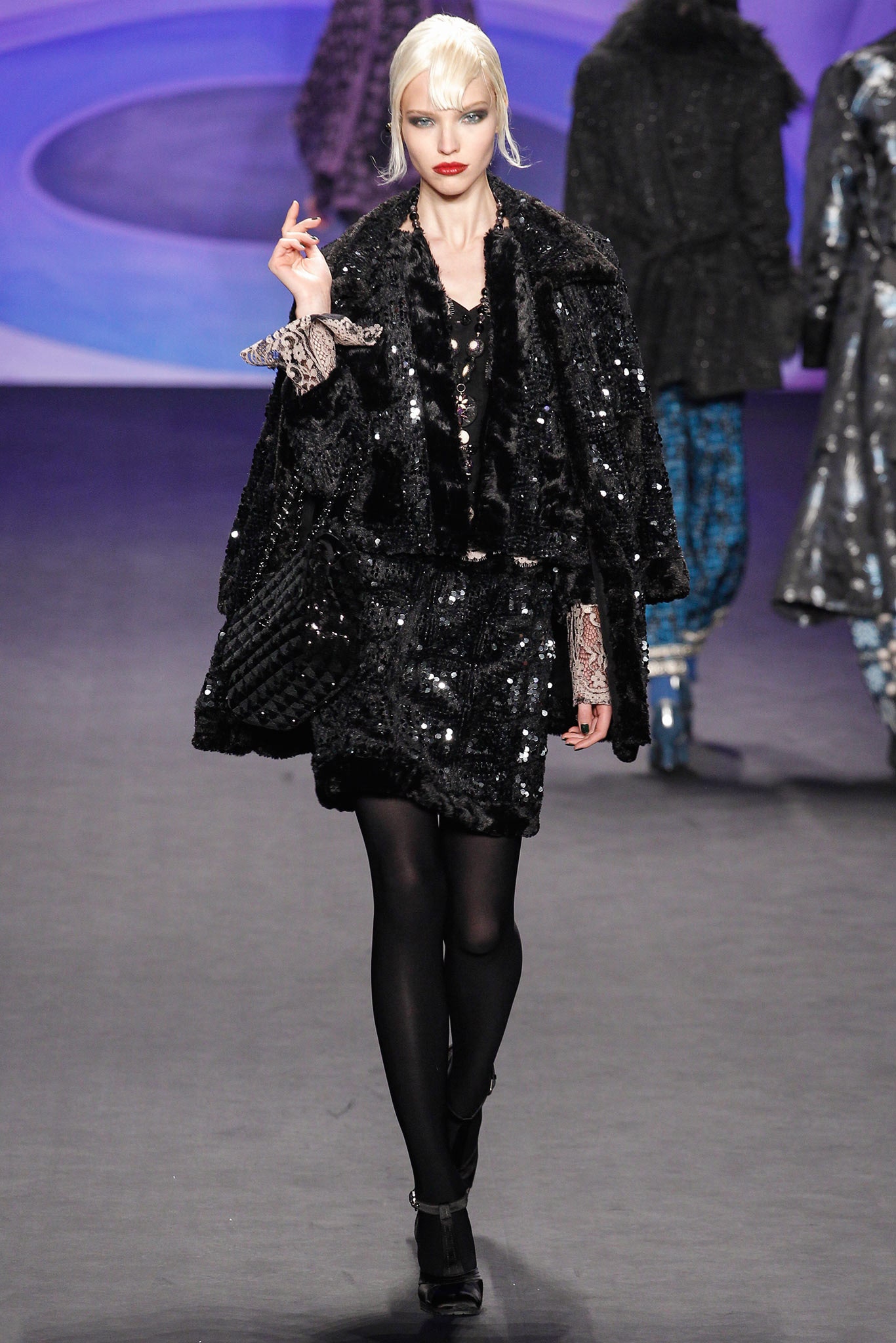 black faux-fur cape and sequin dress