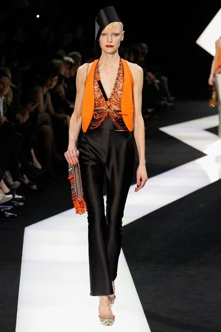 fitted black pants and orange top