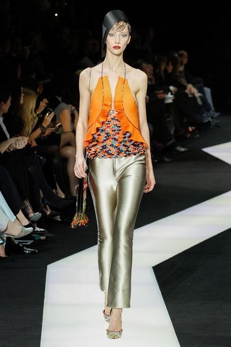 fitted orange top with fringes and gold pants