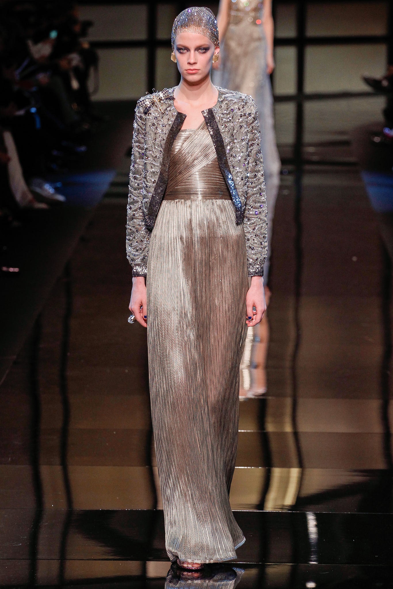 gold pleated gown with gray jacket