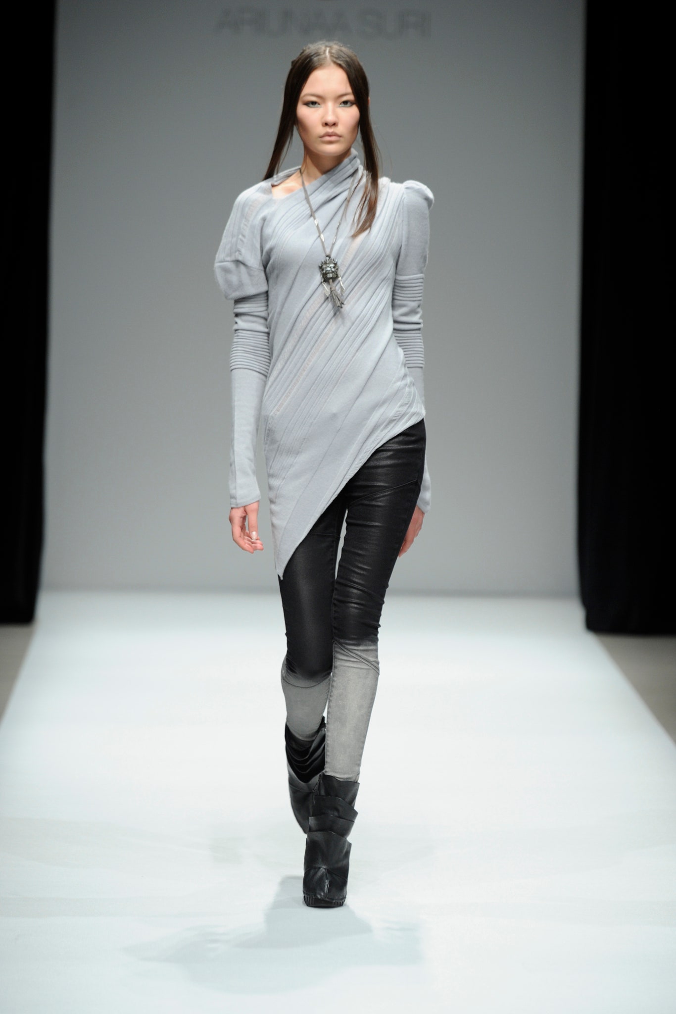 gray asymmetric top with black pants