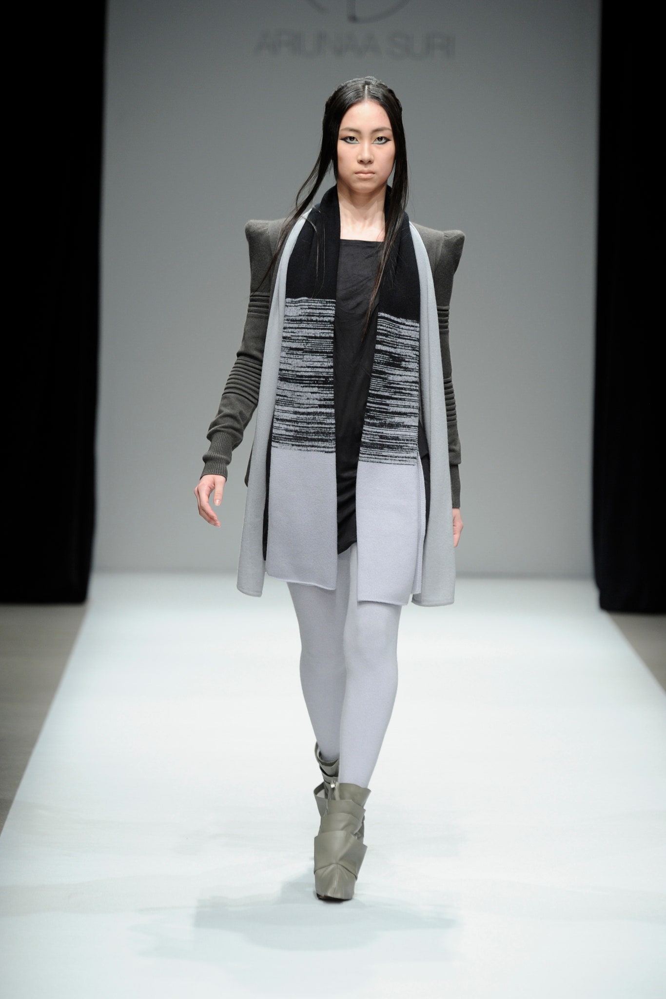 black top gray coat white leggings