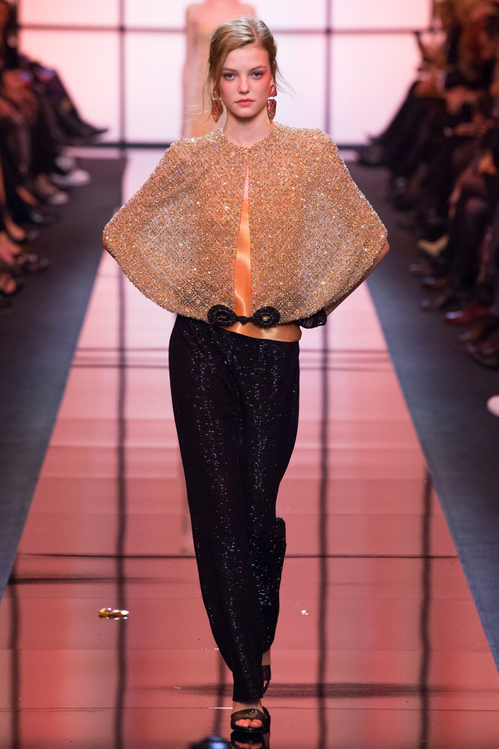 gold beaded cape and black sequined pants