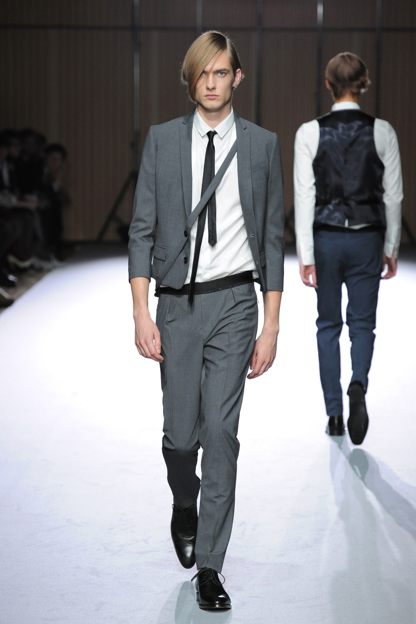 gray tailored suit with black tie