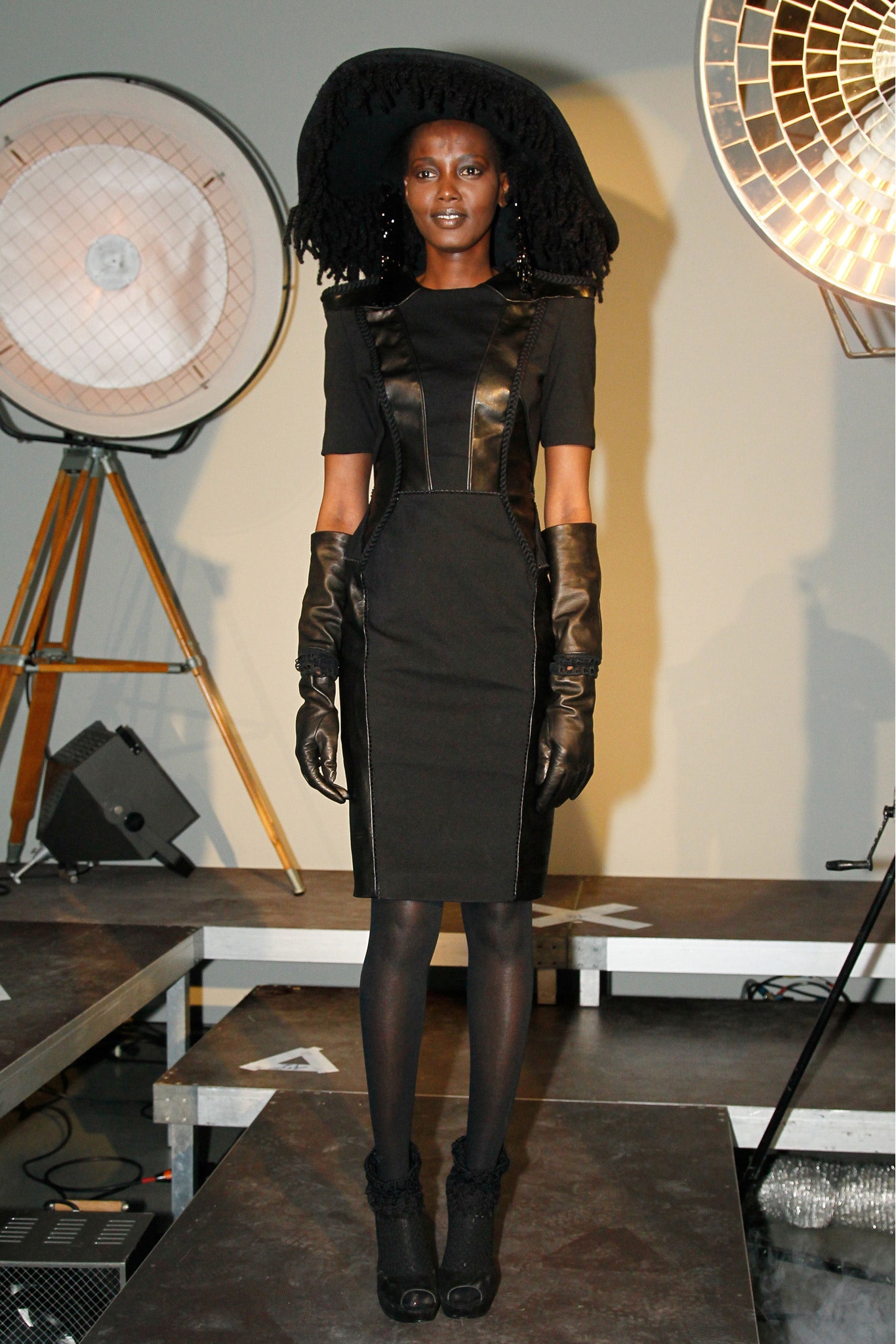 black fitted midi dress with gloves and hat