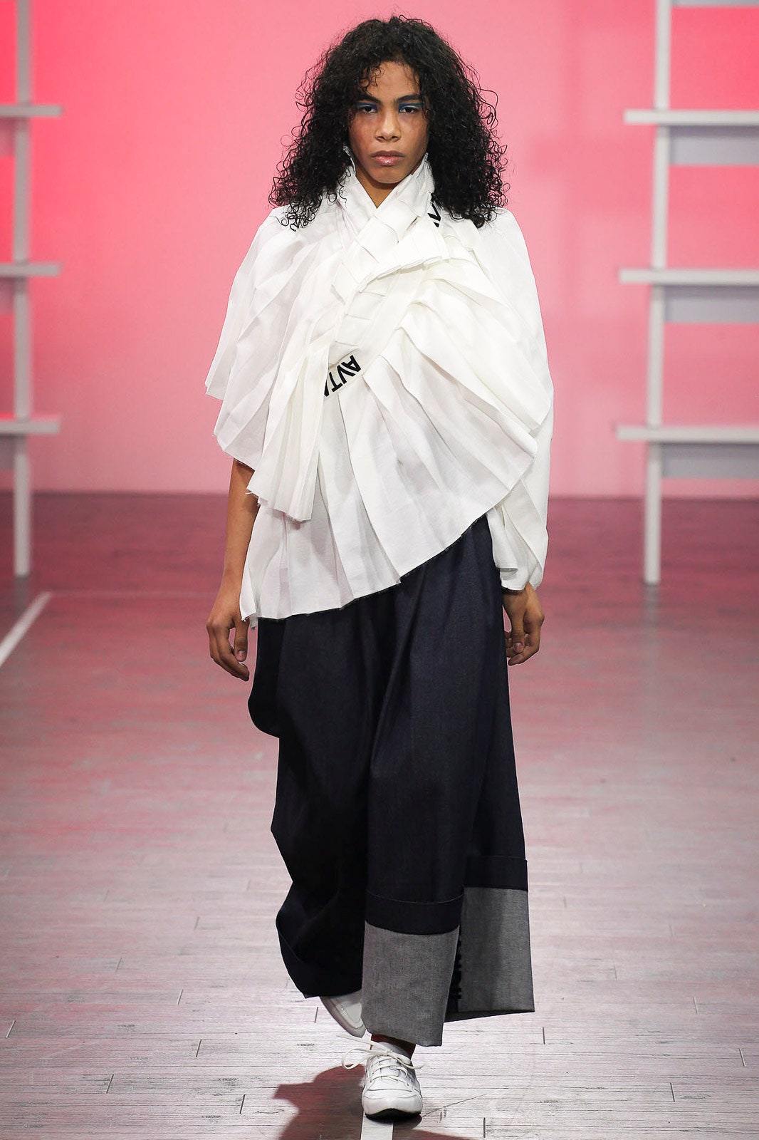 white draped top and blue wide-leg pants