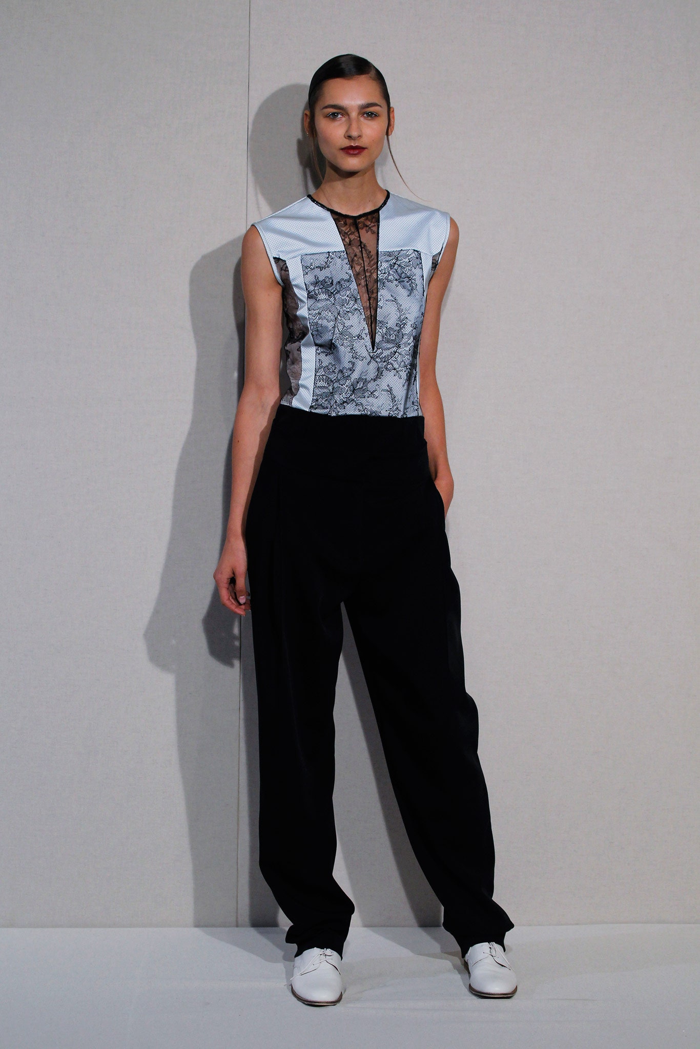 blue embroidered sleeveless top with black pants