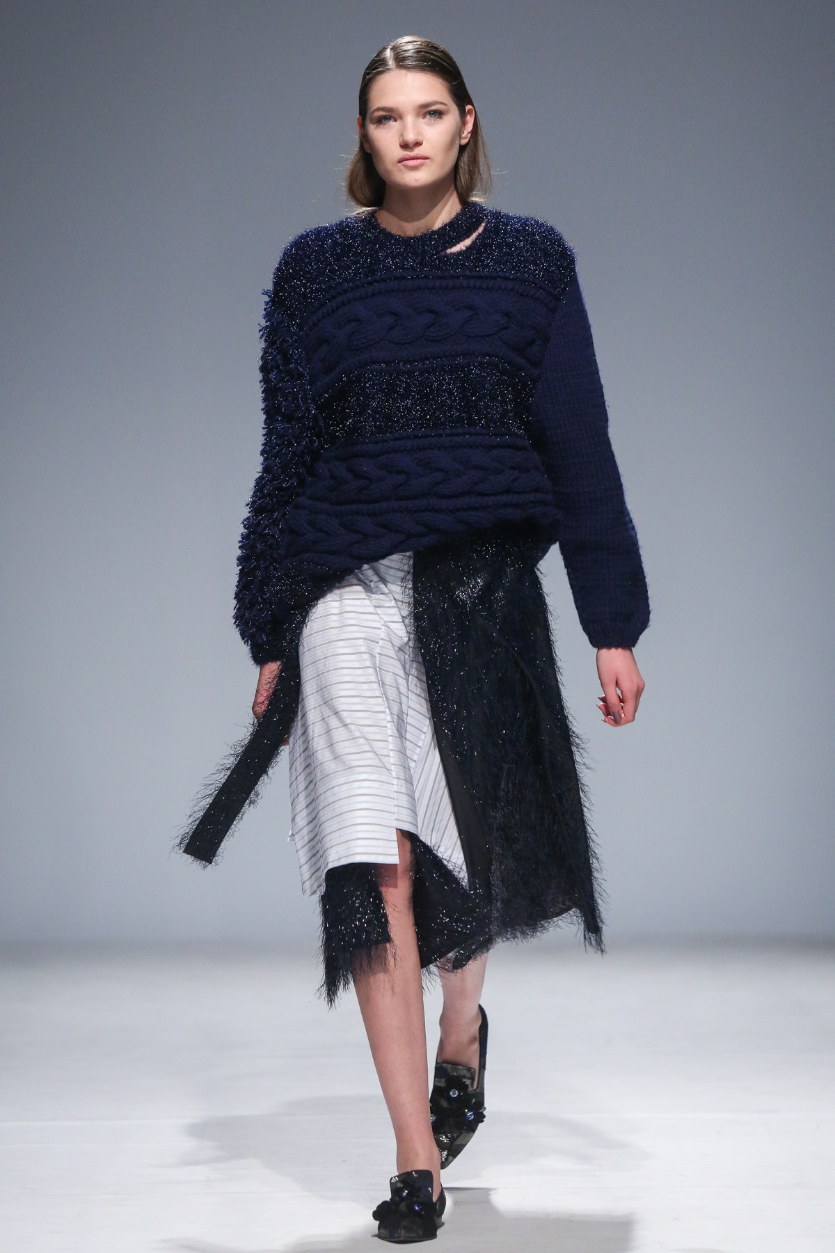 blue textured sweater and striped skirt