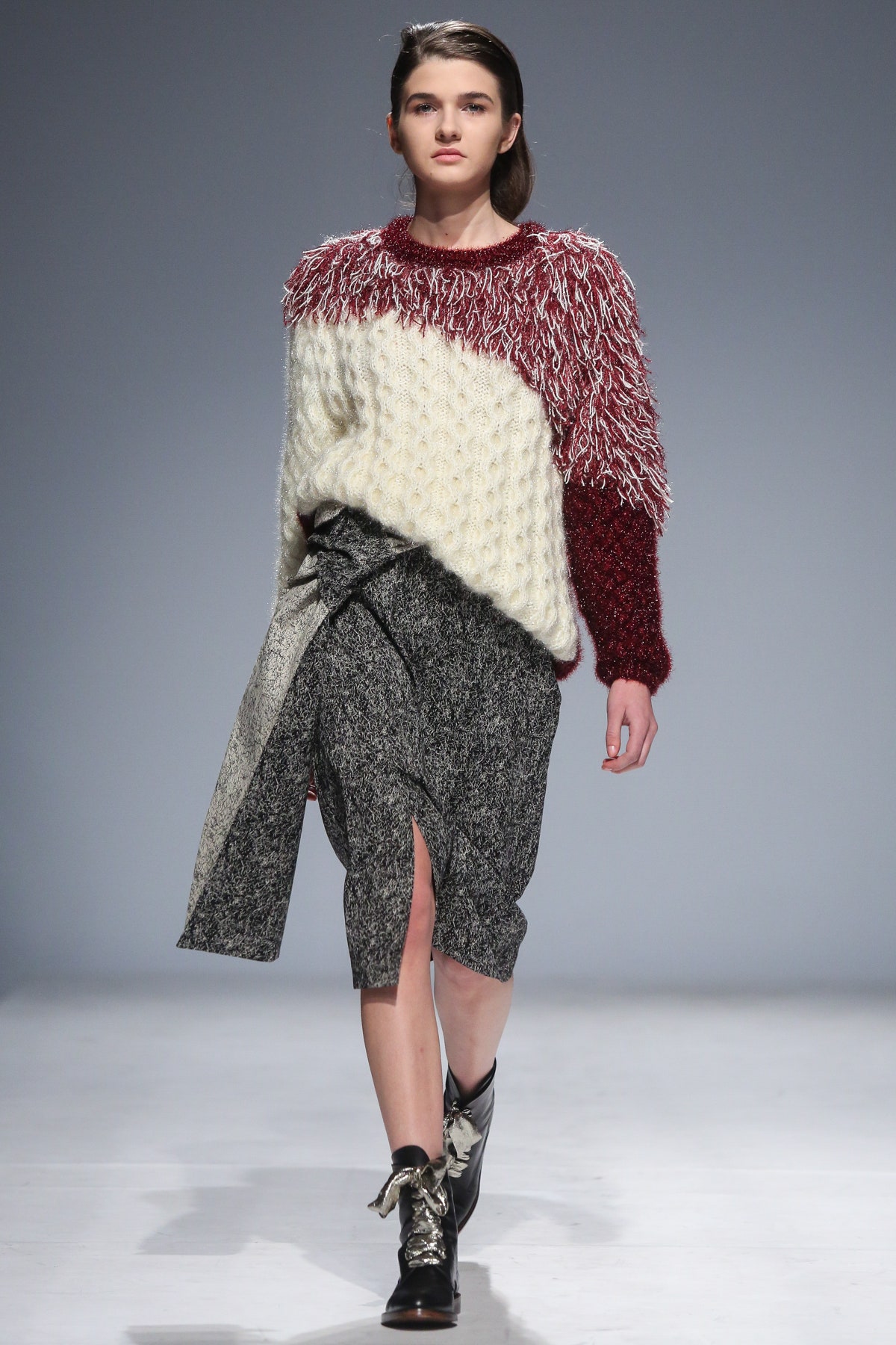 red and white ruffled sweater with gray skirt