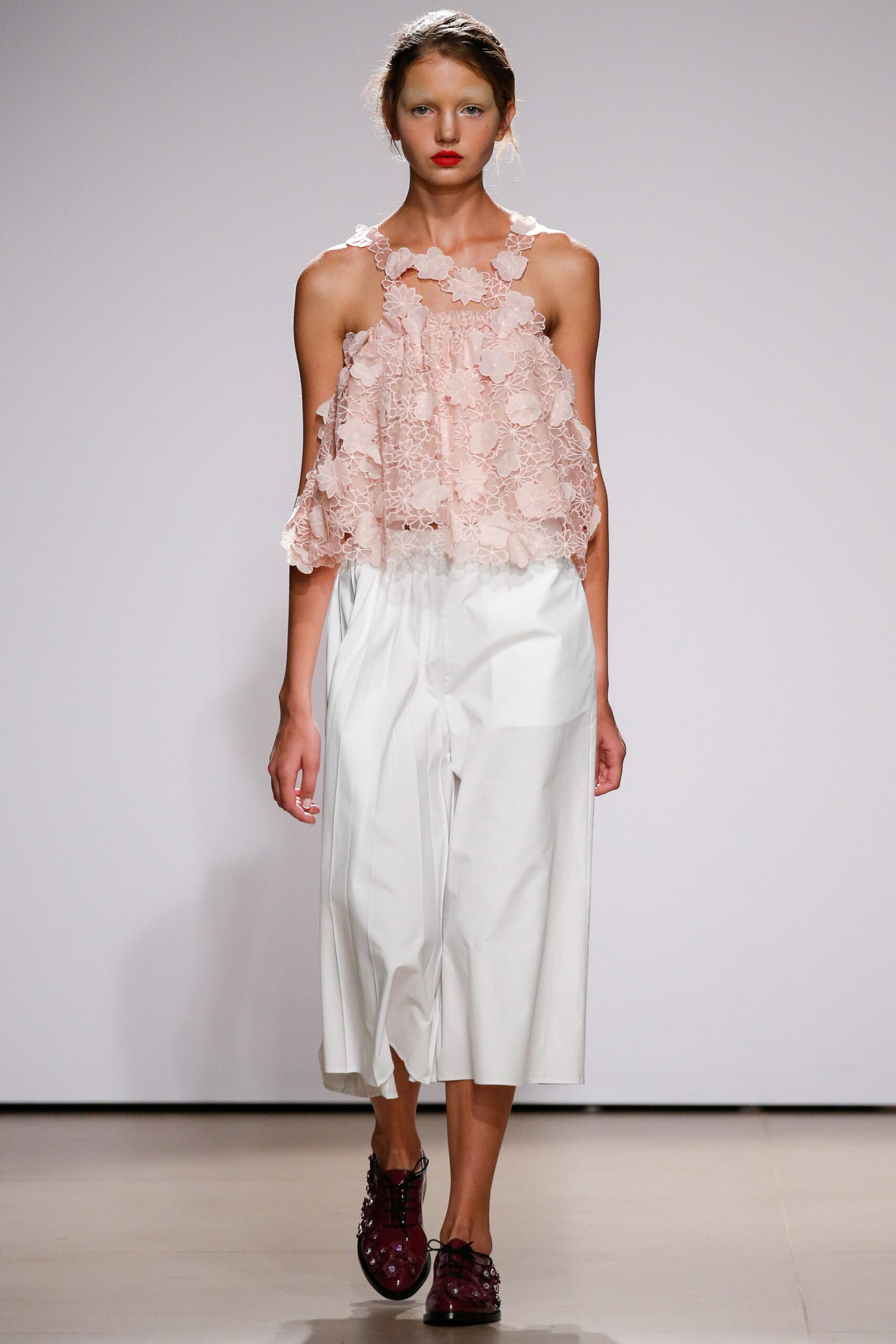 pink lace sleeveless top and white wide-leg pants