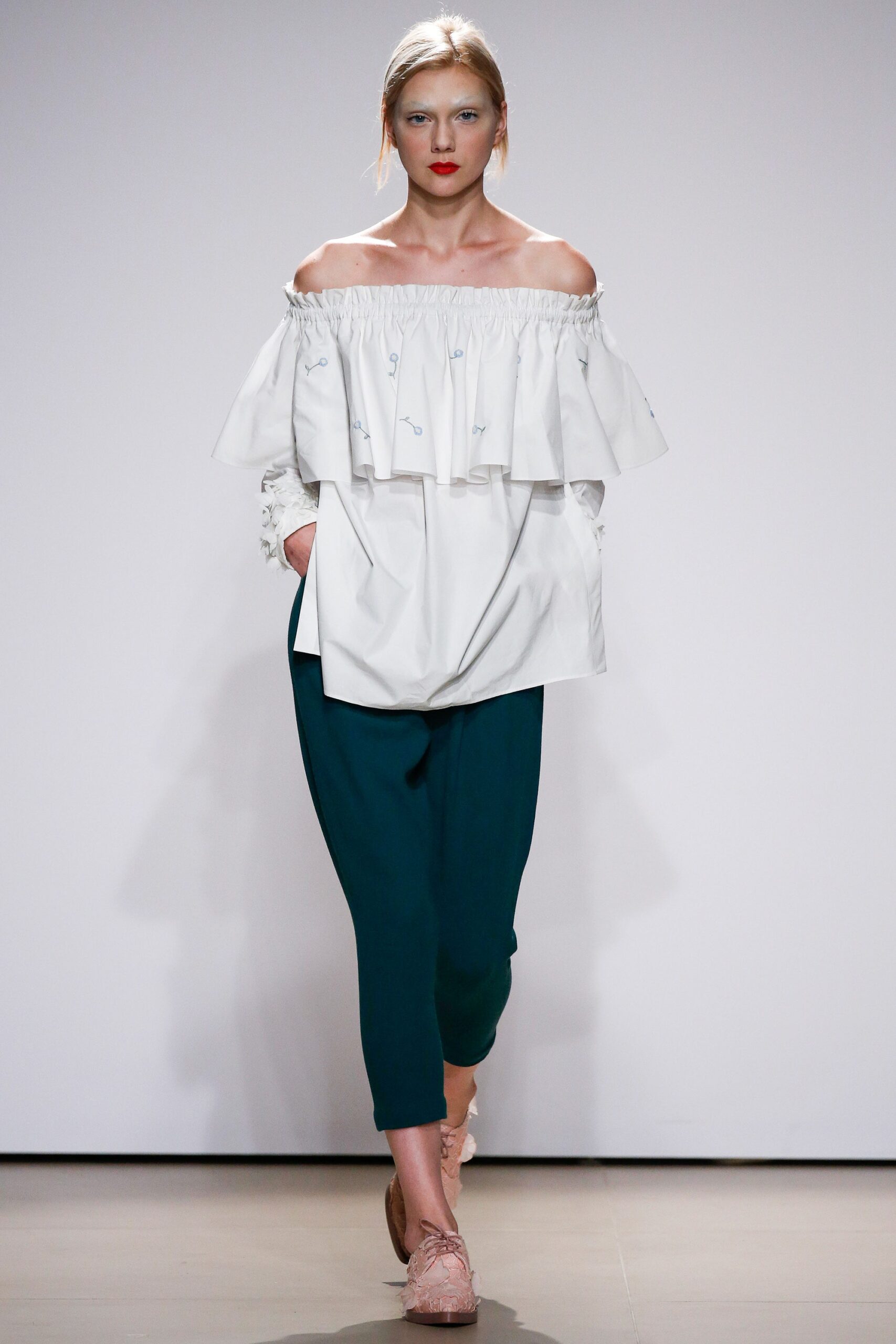 white off-shoulder blouse with green pants