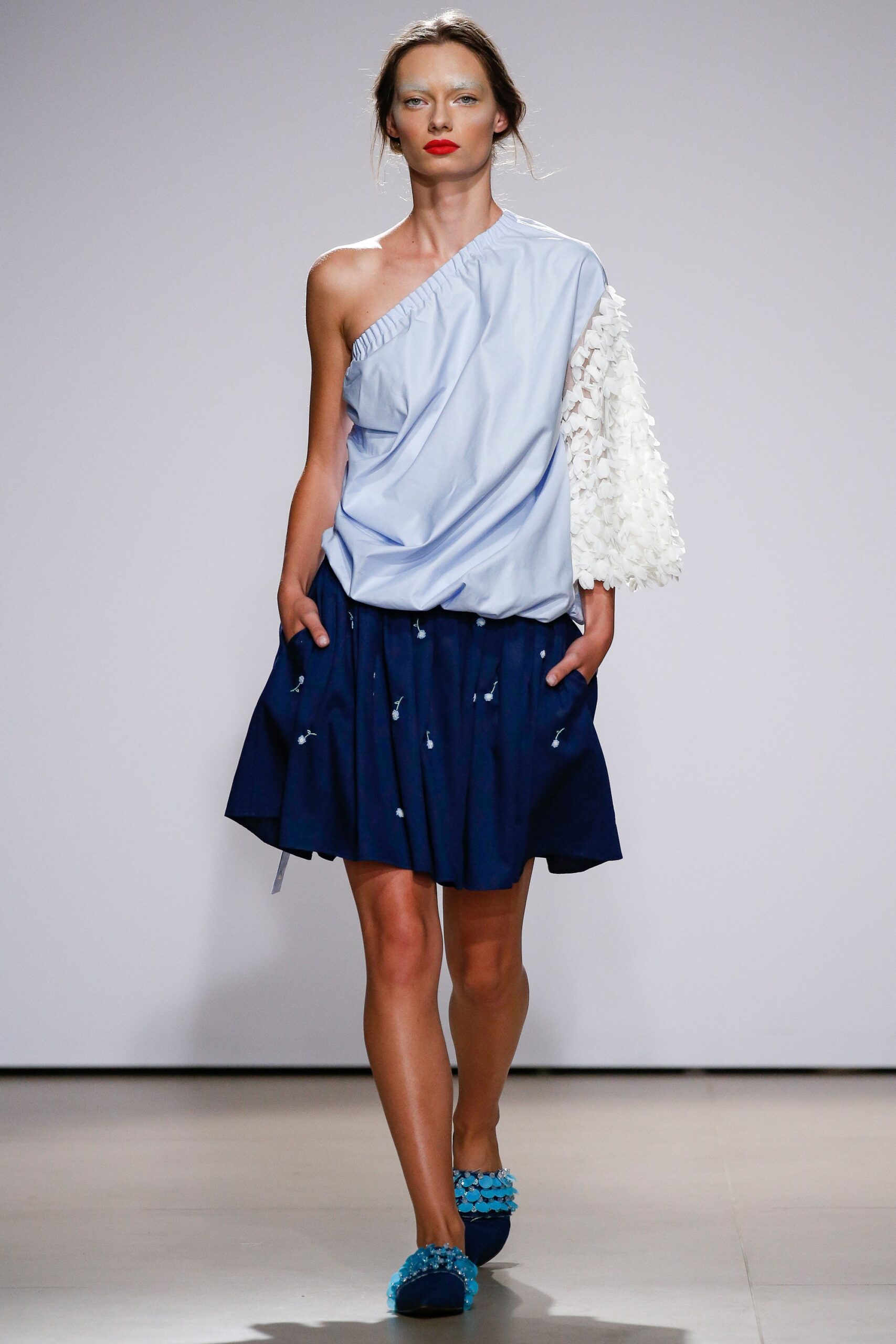 blue asymmetric top and navy pleated skirt